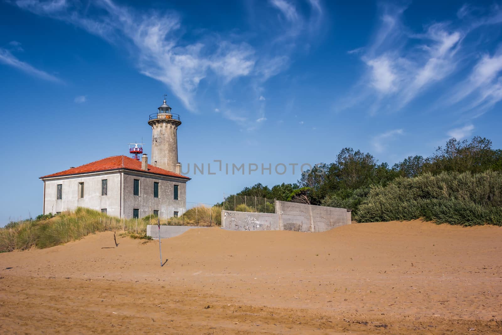 The lighthouse on the beach at the mouth of the river Tagliamento, Bibione, Venezia, Italy. Nice sunny weather. Famous travel destination. by petrsvoboda91