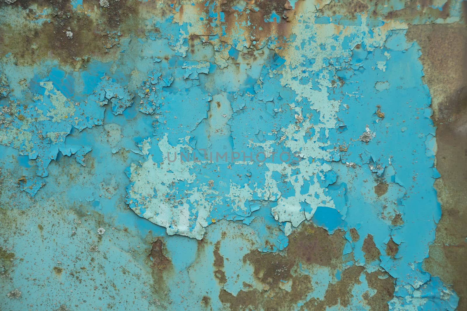 Multicolored background: old rusty metal surface with blue paint flaking and cracking texture