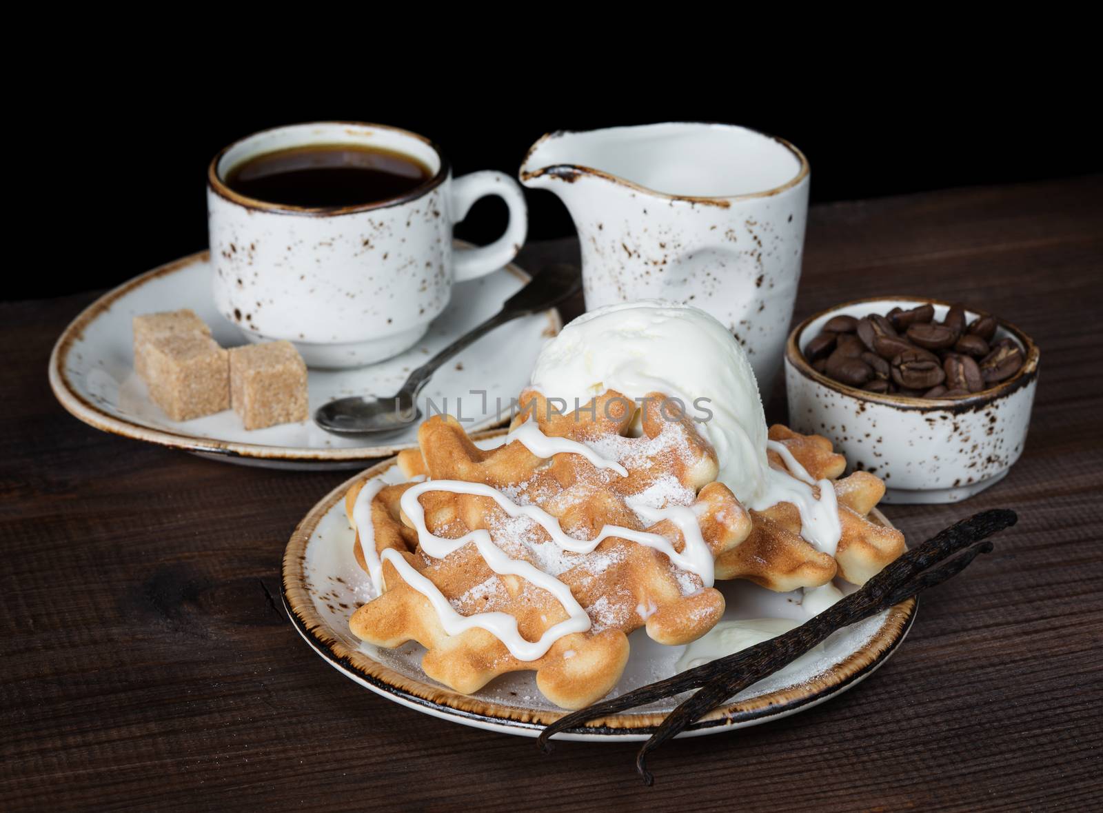 Cup of coffee, waffles and vanilla ice cream on dark background