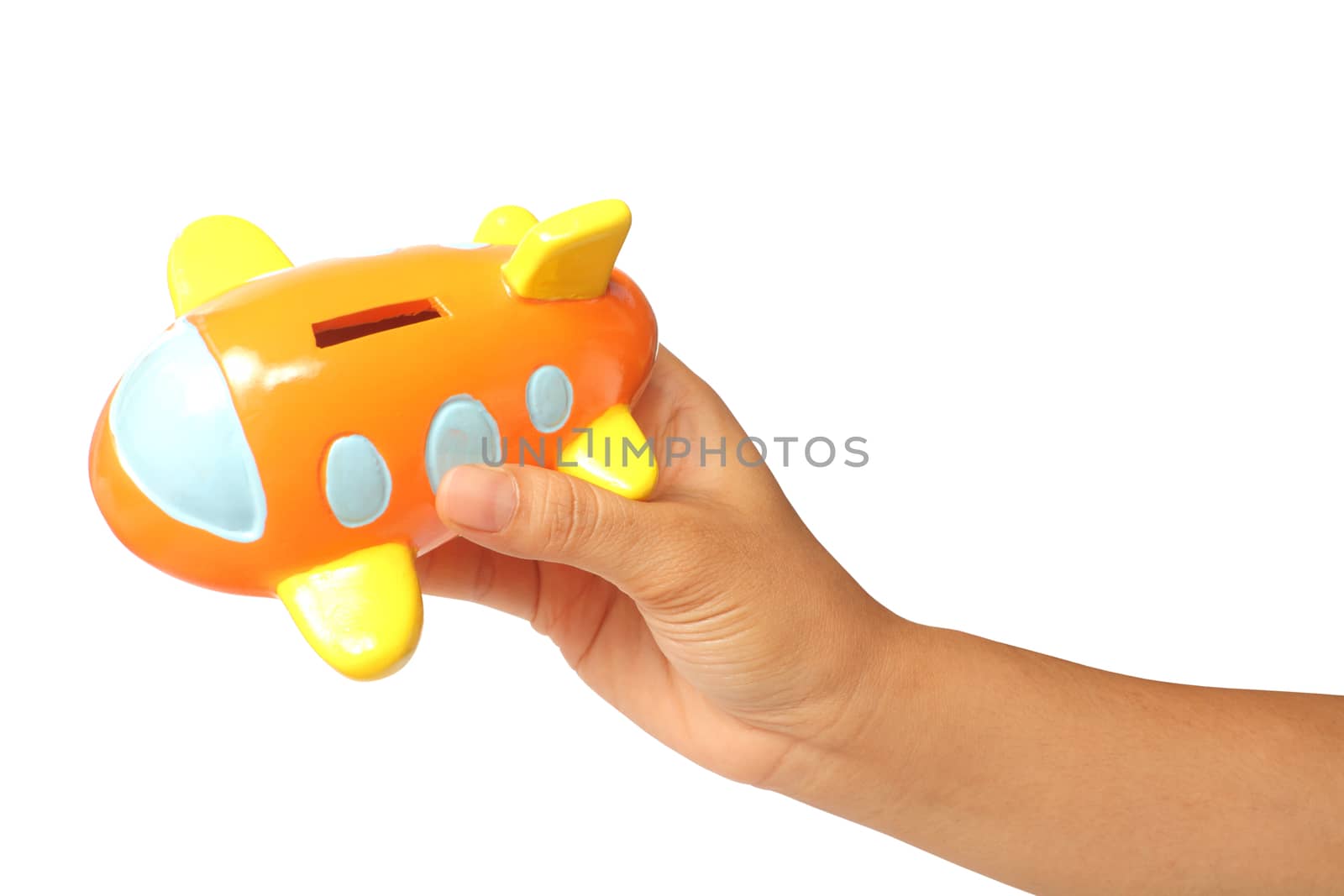 Young hand holding a saving airplane bank isolated on white with clipping path, travel theme. 