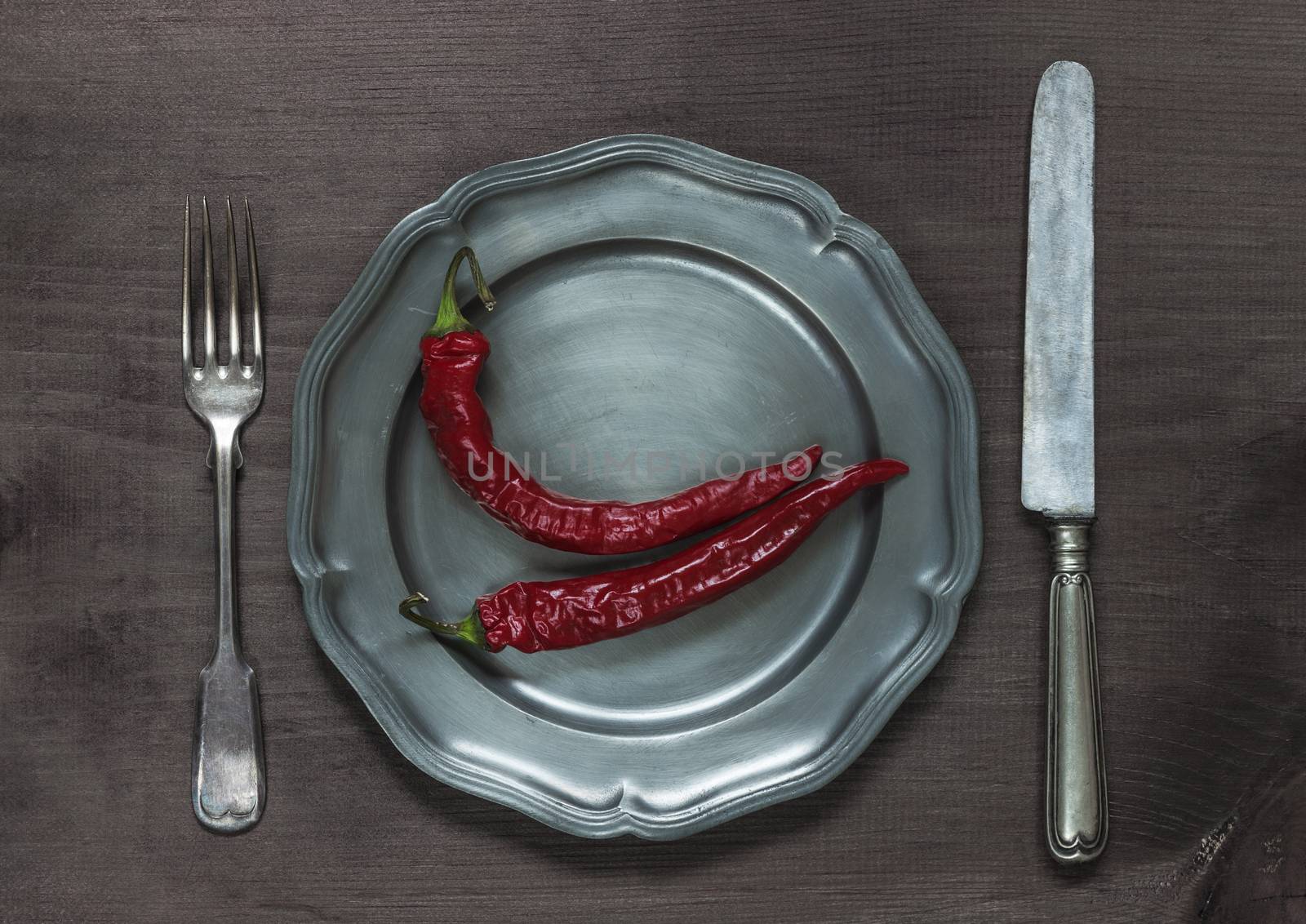 Chilli peppers on pewter plate by Epitavi