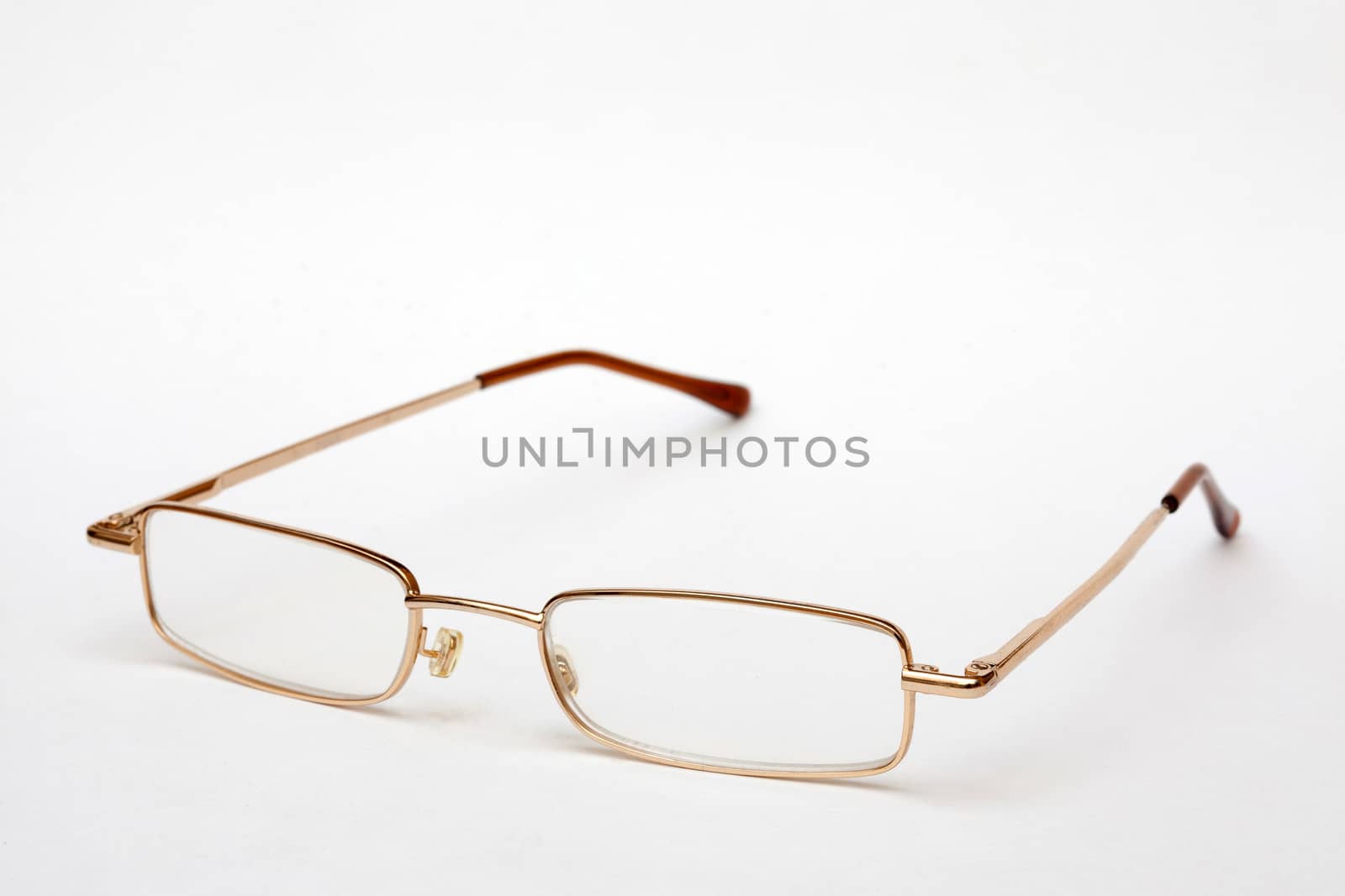 Glasses in thin metal frame on white background. Vision correction.