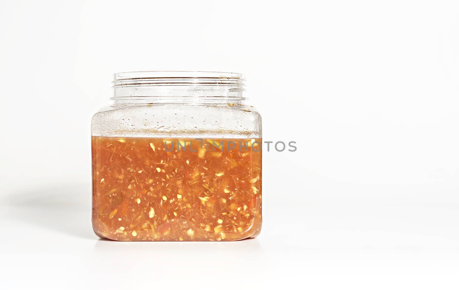 Homemade  garlic and chilli sauce in plastic jar , Asian style cuisine