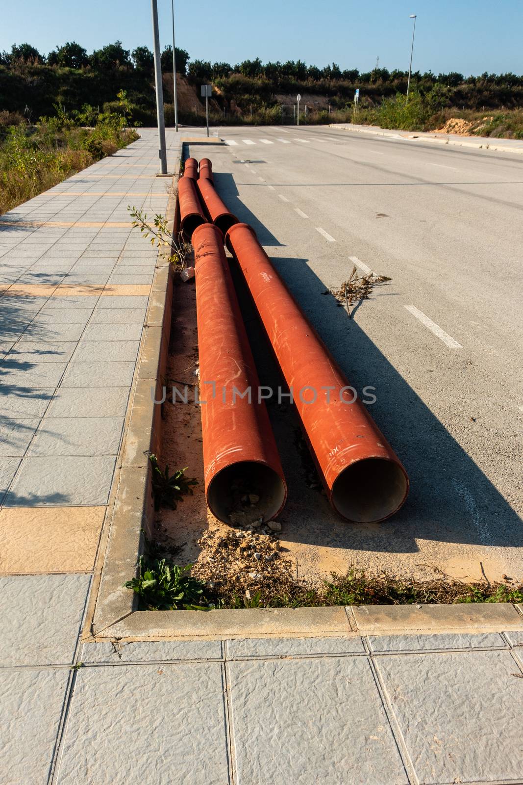 pipes at roadside ready to be laid on spanish urbanisation