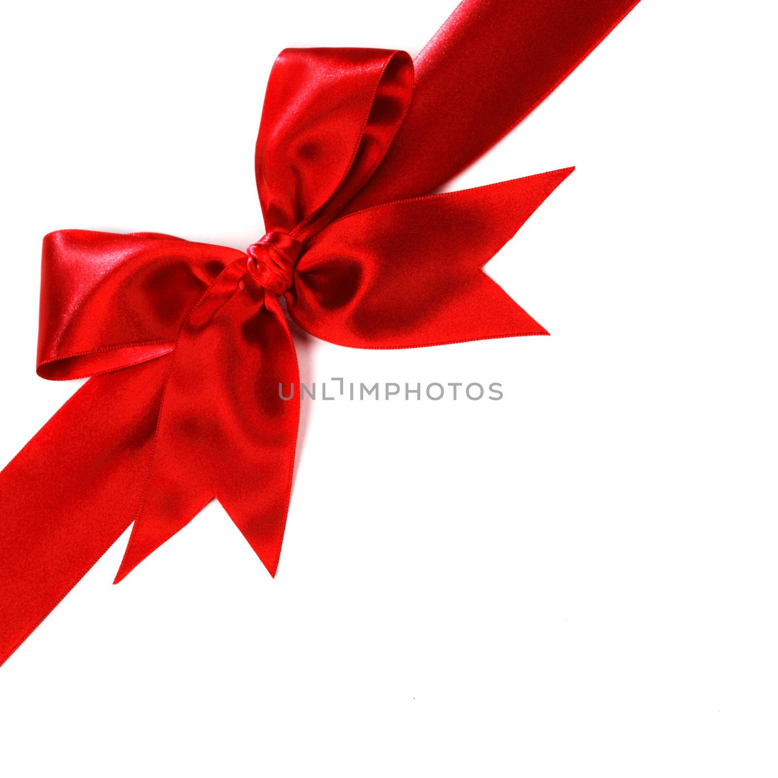 Shiny red satin ribbon and bow isolated on white background