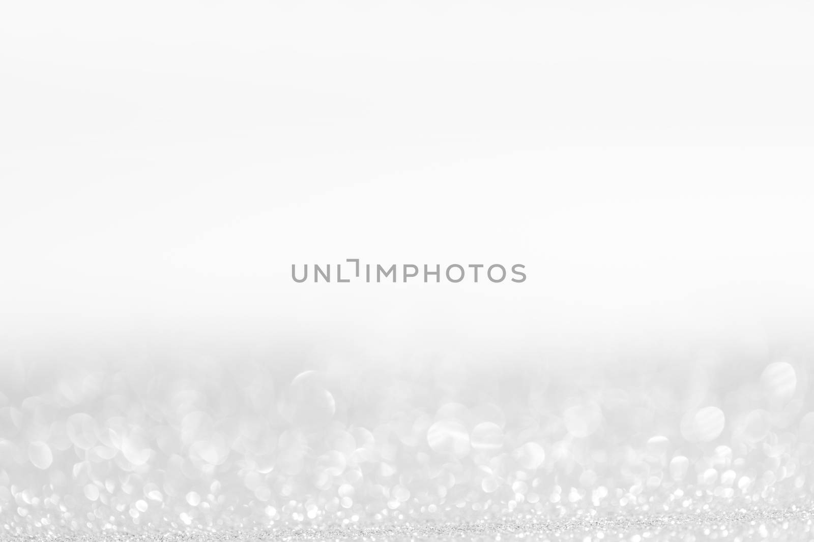 Abstract shining glitters silver holiday bokeh background with copy space for text