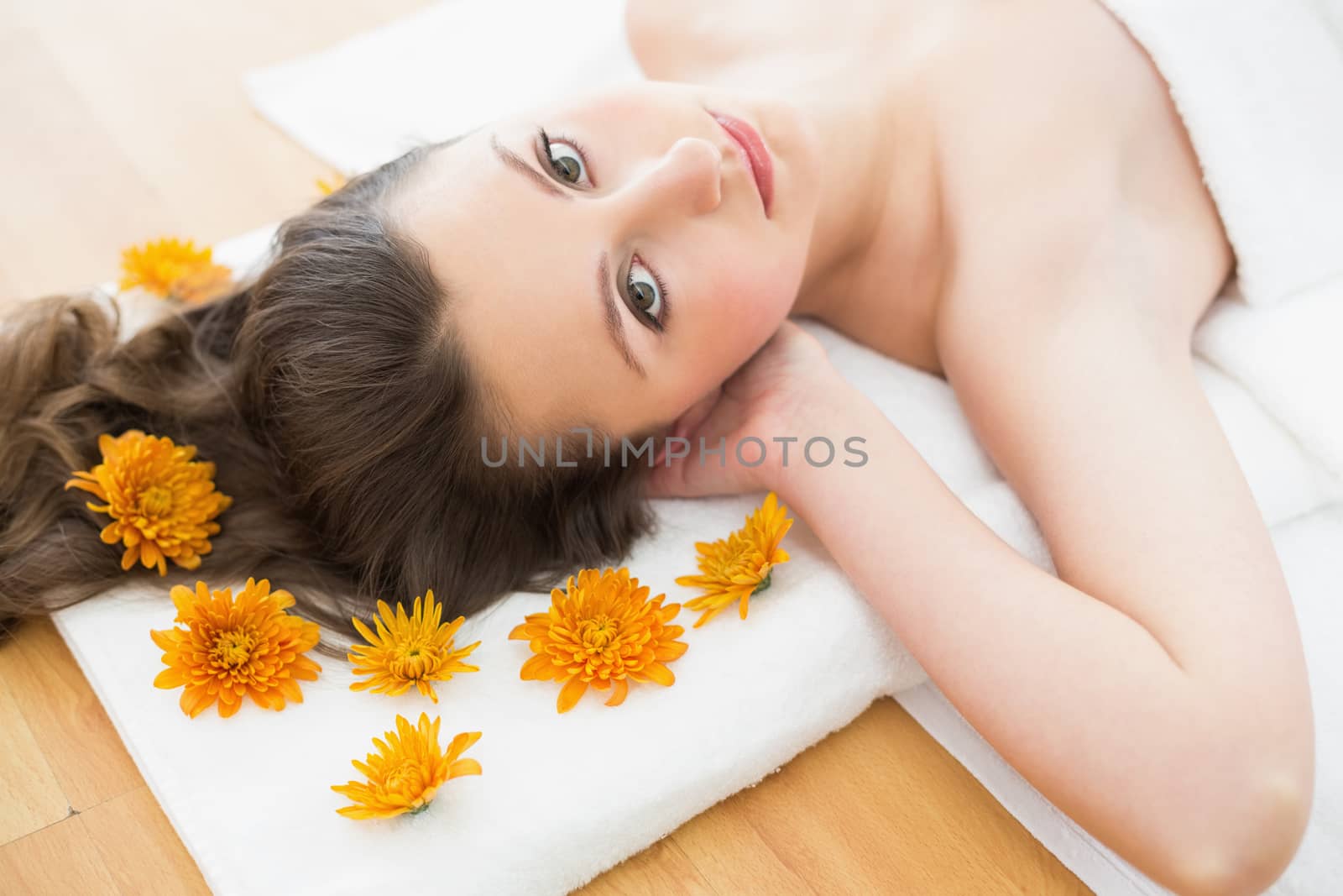 Overhead portrait of a young brunette lying on massage table in beauty salon