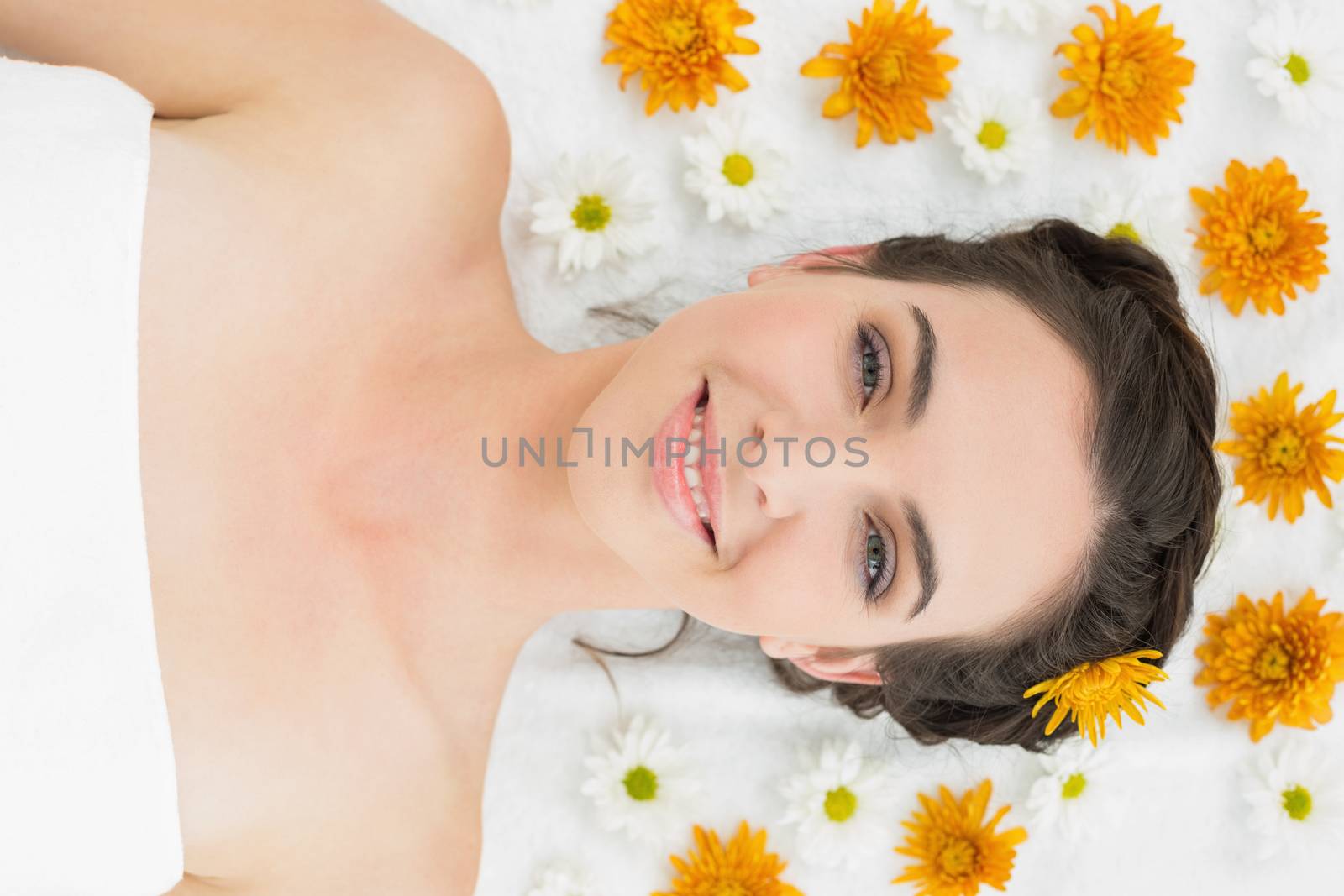Close up portrait of a beautiful young woman with flowers in beauty salon
