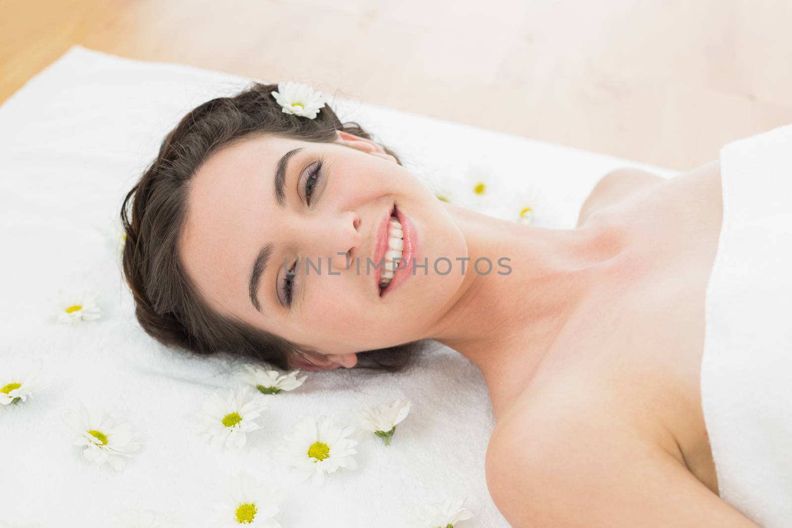 Close up portrait of a beautiful young woman with flowers in beauty salon