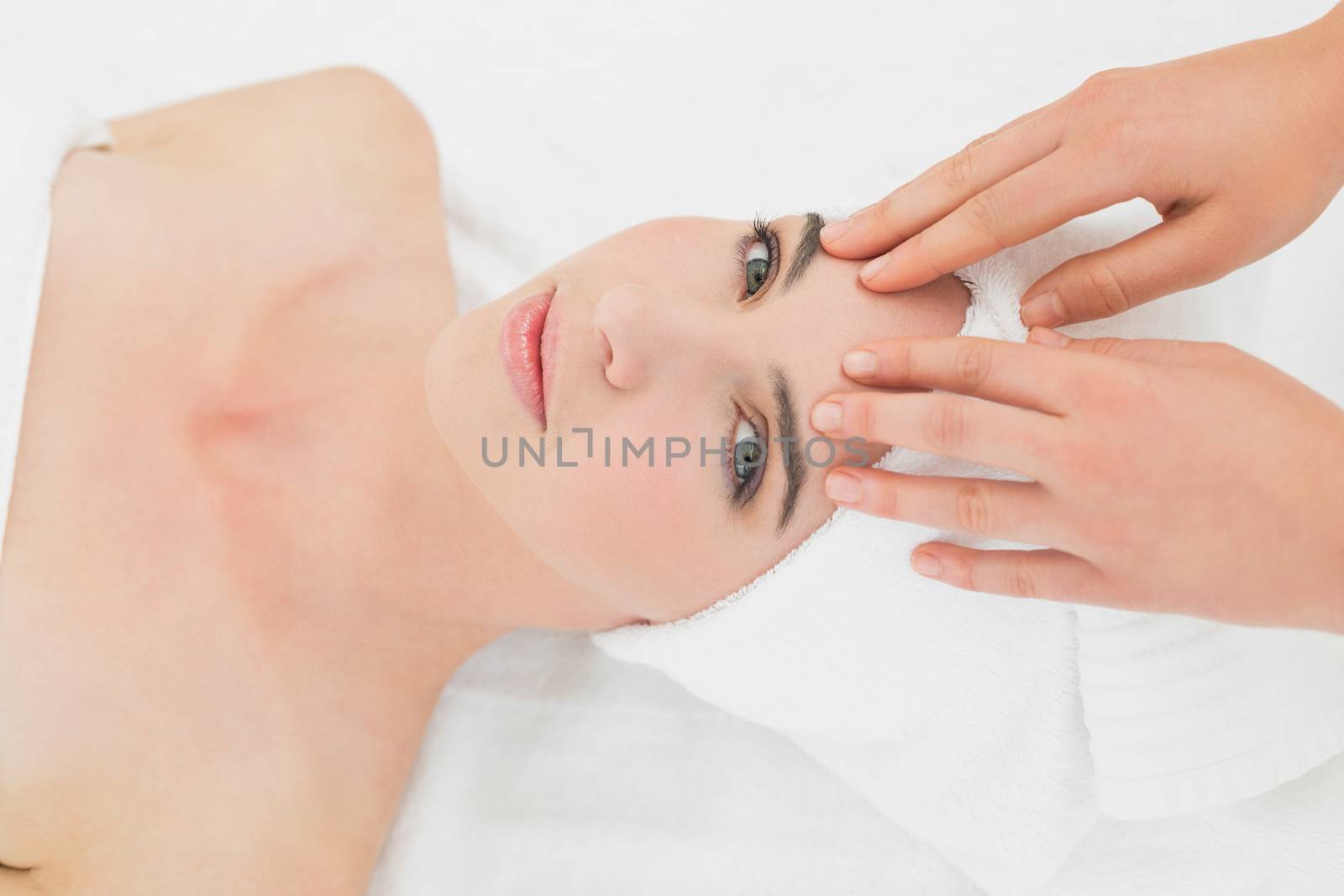 Hands massaging womans forehead at beauty spa by Wavebreakmedia