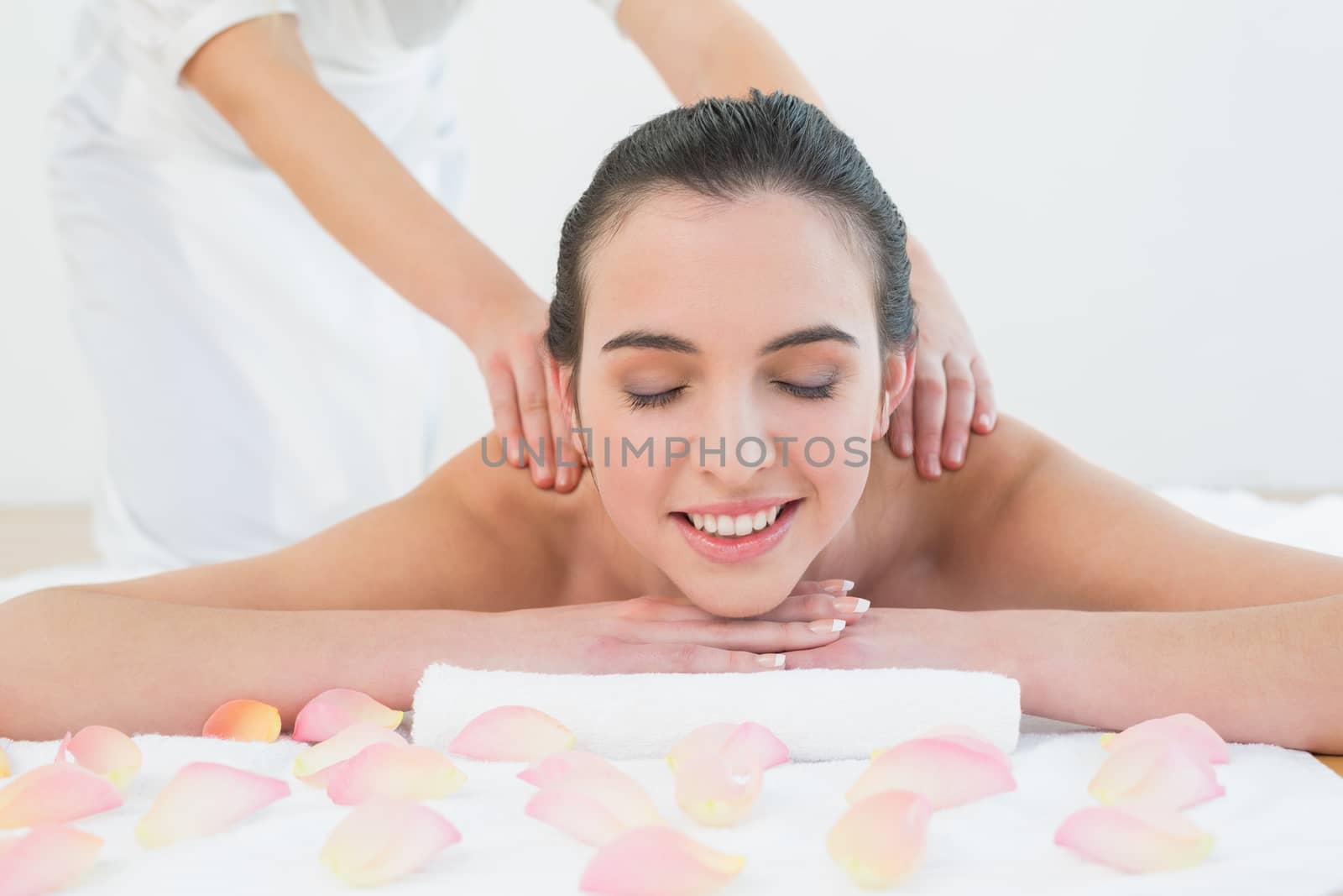 Close up of a beautiful woman enjoying back massage at beauty spa