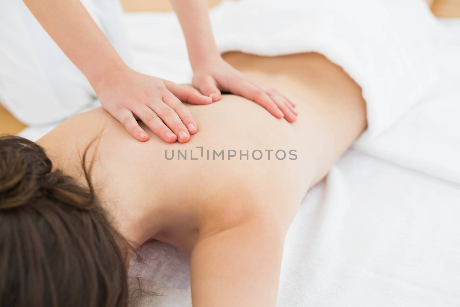 Woman enjoying back massage at beauty spa by Wavebreakmedia