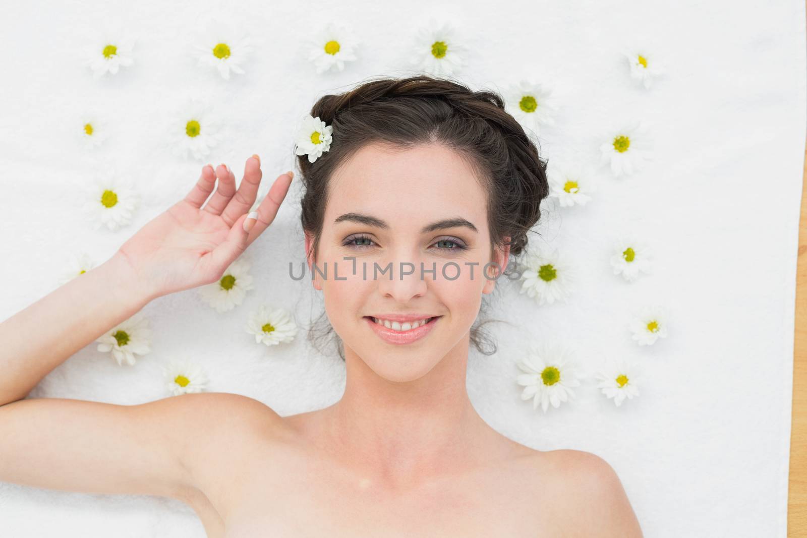 Overhead portrait of a beautiful young woman with flowers in beauty salon