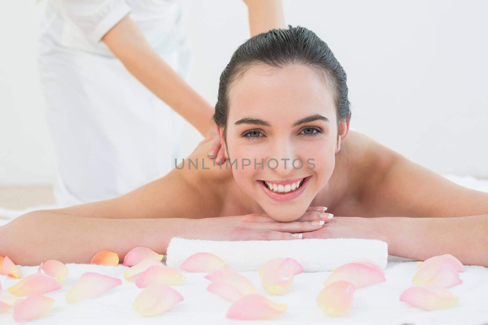 Close up of a beautiful woman enjoying back massage at beauty spa