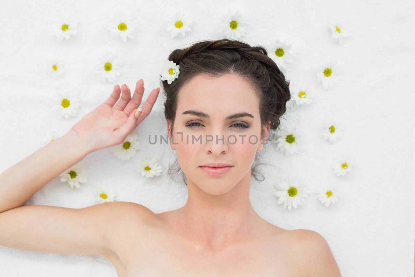 Overhead portrait of a beautiful young woman with flowers in beauty salon