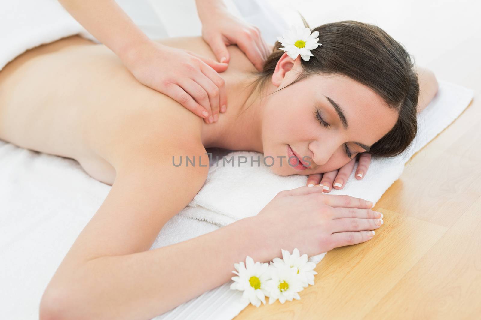 Close up of a beautiful woman enjoying back massage at beauty spa
