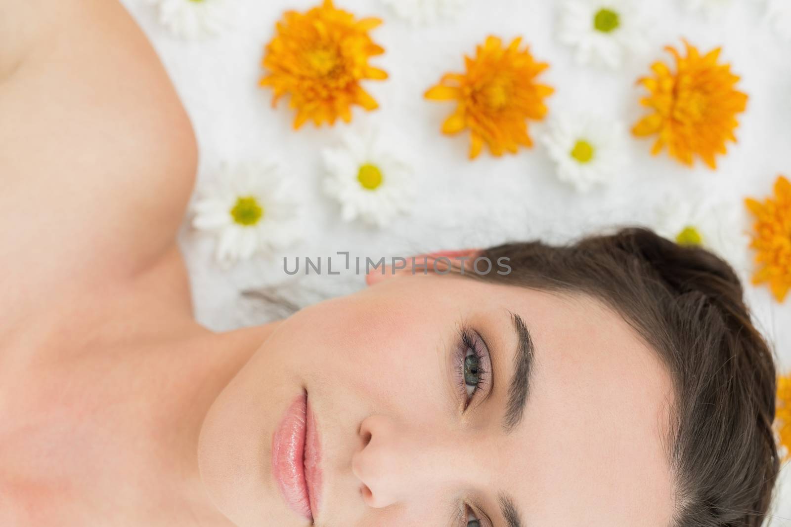 Close up portrait of a beautiful young woman with flowers in beauty salon