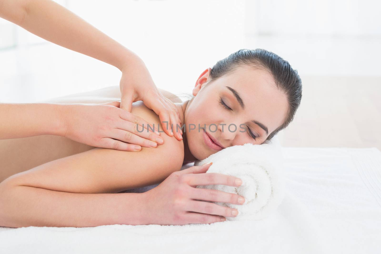 Close up of a beautiful woman enjoying back massage at beauty spa