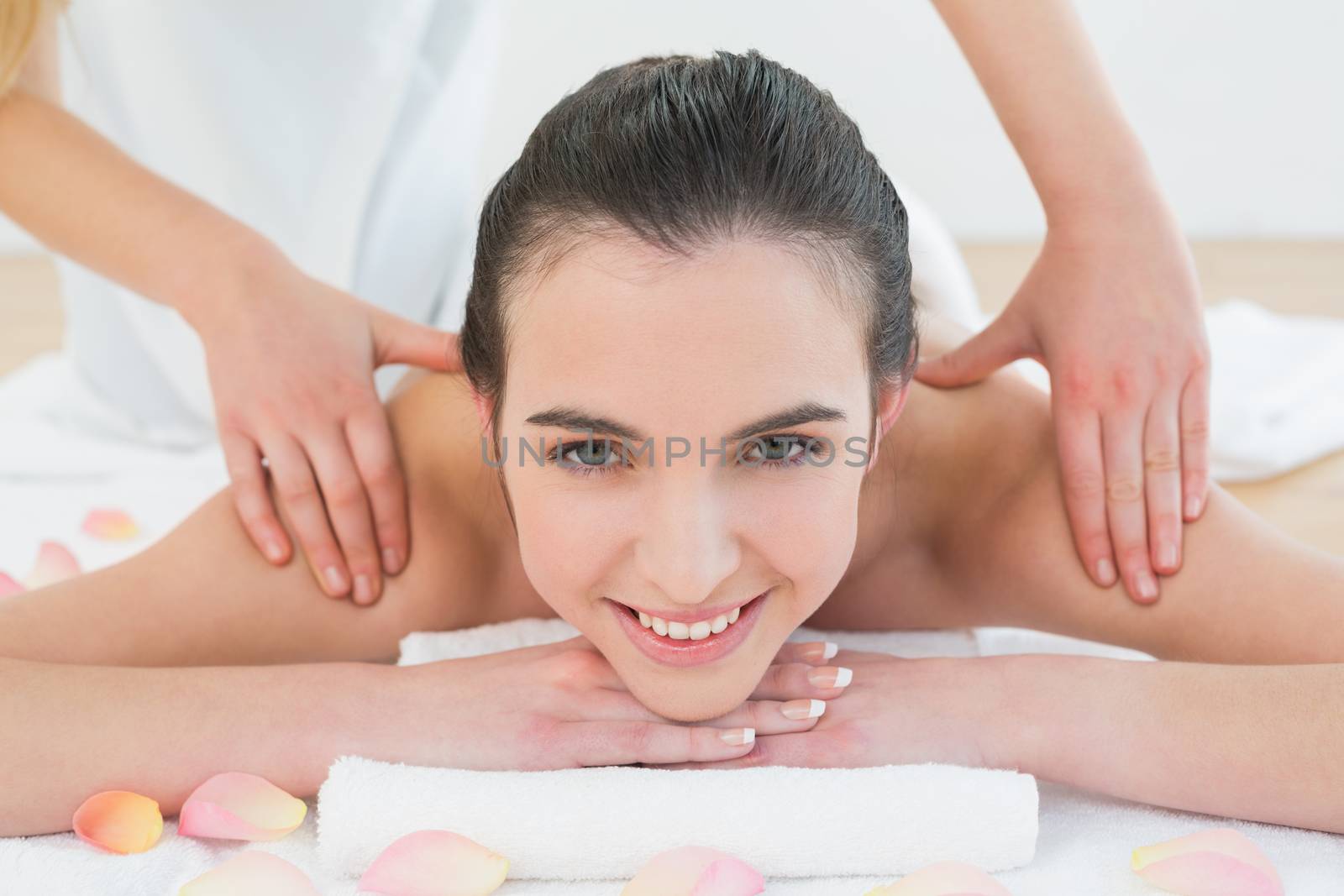 Beautiful woman enjoying shoulder massage at beauty spa by Wavebreakmedia