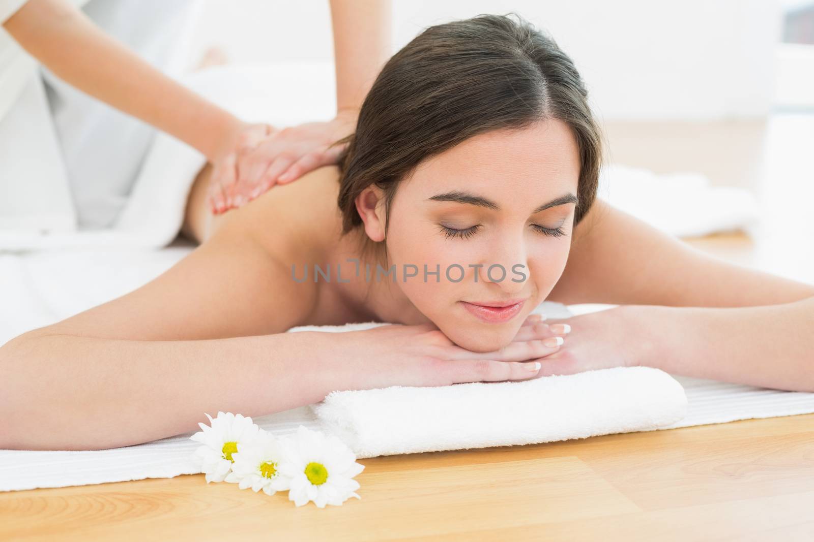 Close up of a beautiful woman enjoying back massage at beauty spa