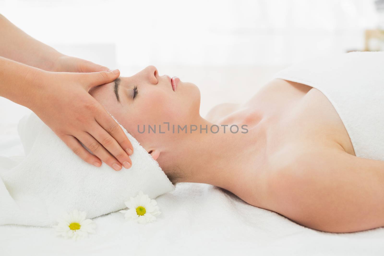 Hands massaging womans face at beauty spa by Wavebreakmedia