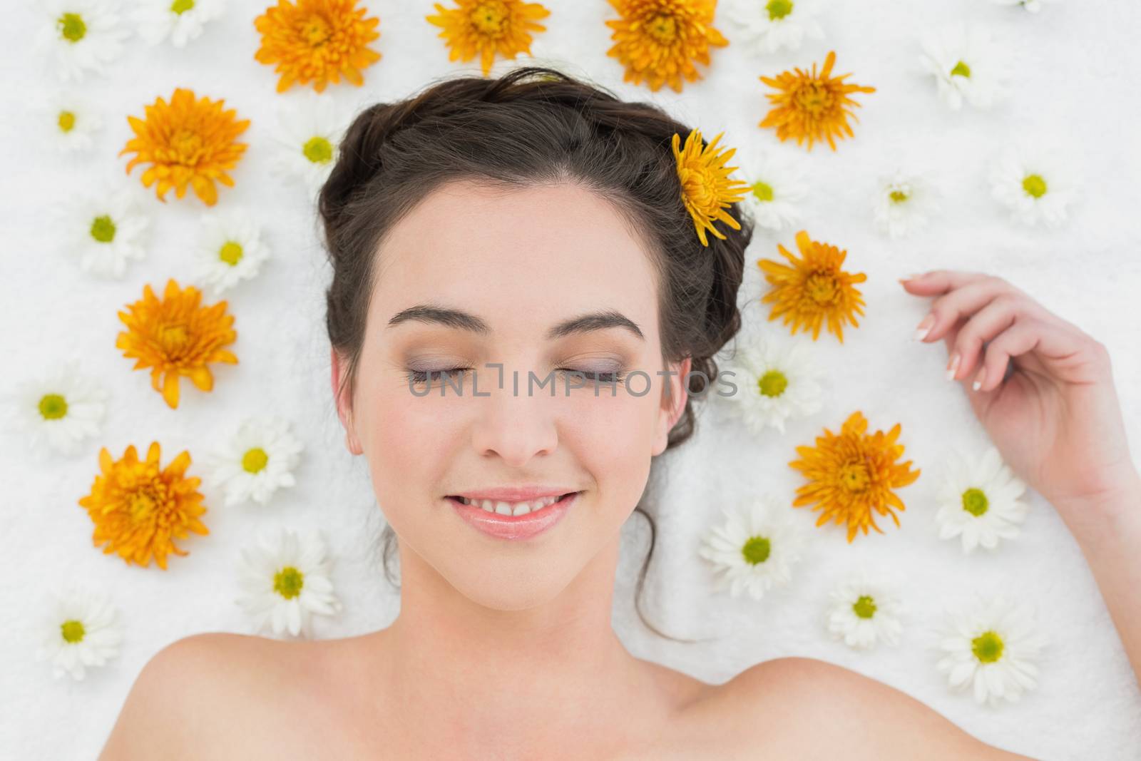 Close up of a beautiful young woman with flowers in beauty salon