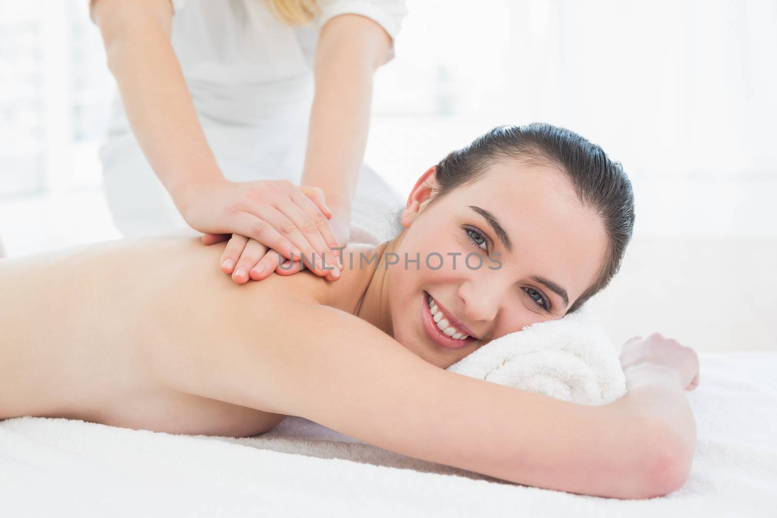 Close up of a beautiful woman enjoying back massage at beauty spa