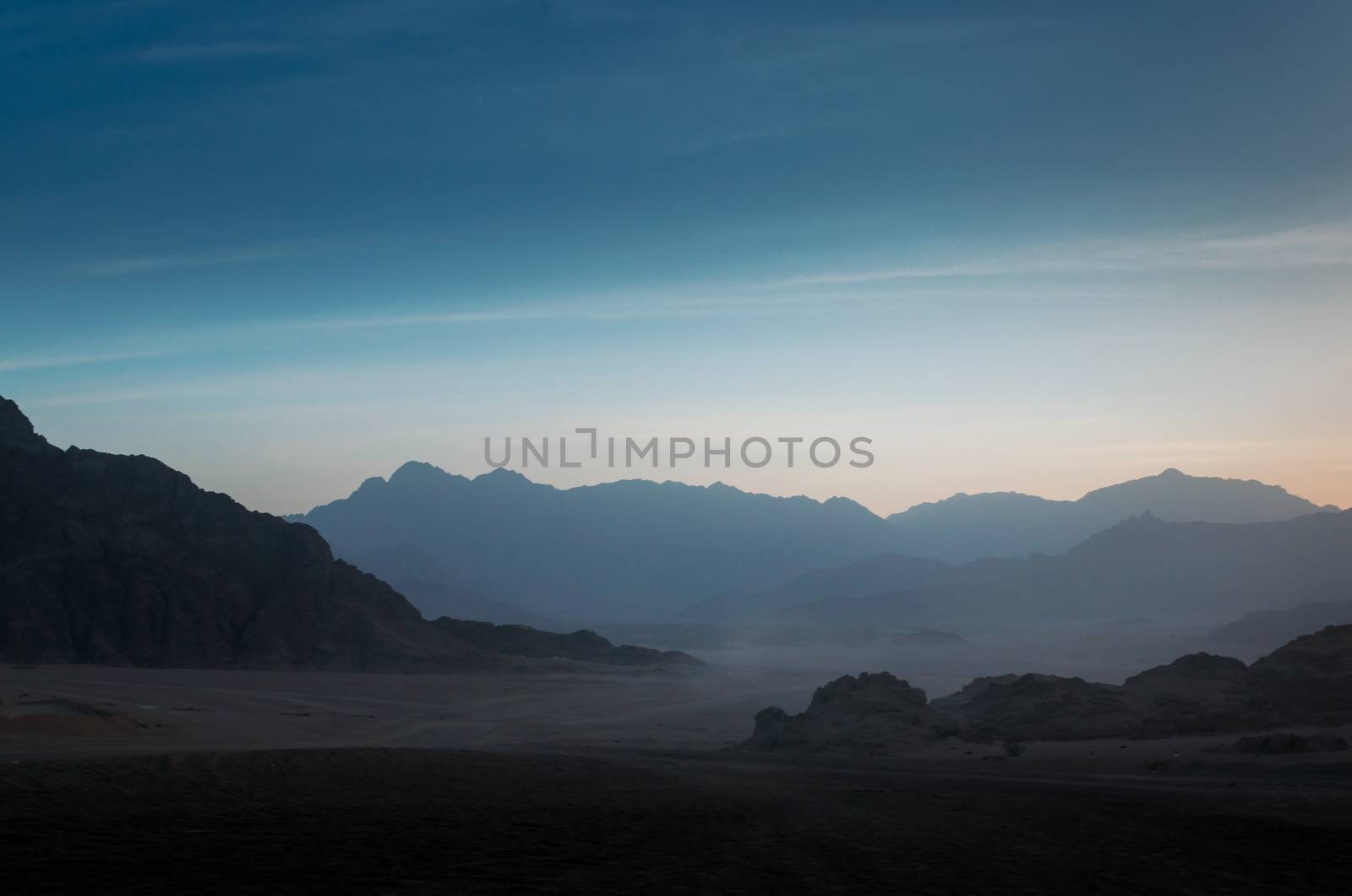 night desert landscape with rocky mountains and sunset sky with clouds in Sharm El Sheikh Egypt