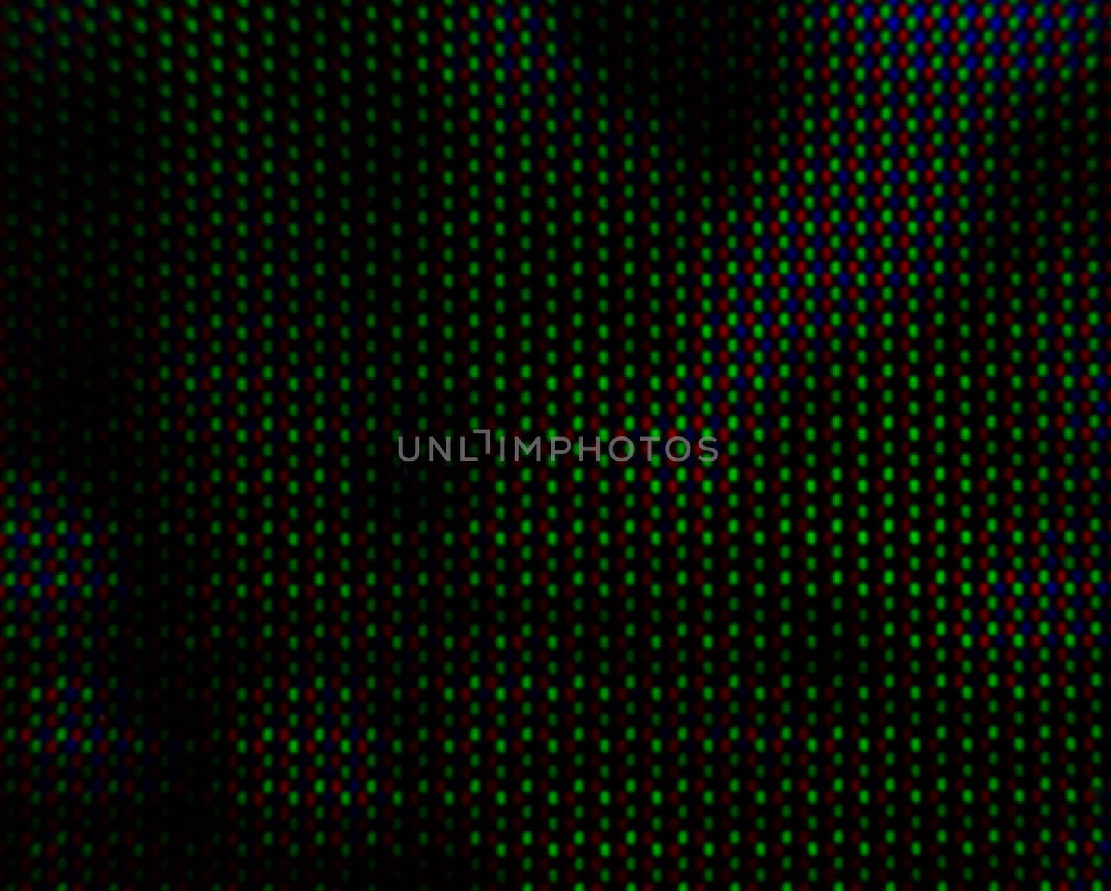 abstract background pattern of colored blurry dots on a dark background close up