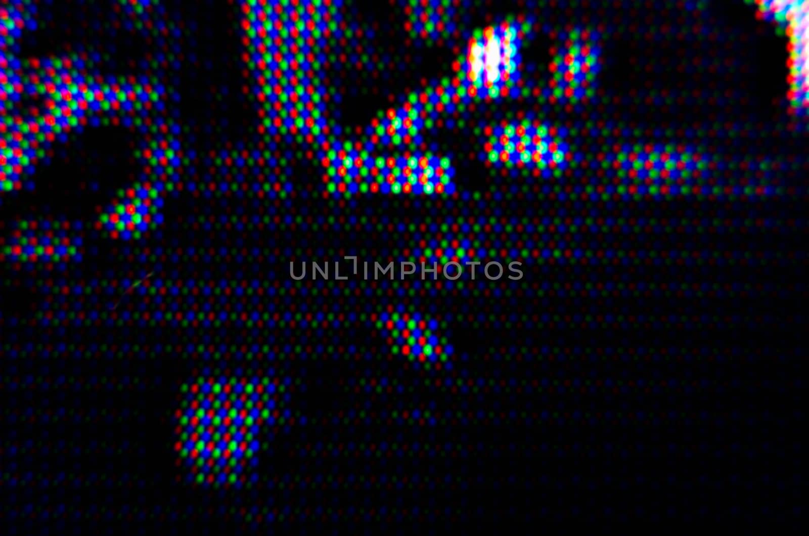 abstract background pattern of colored blurry dots on a dark background close up