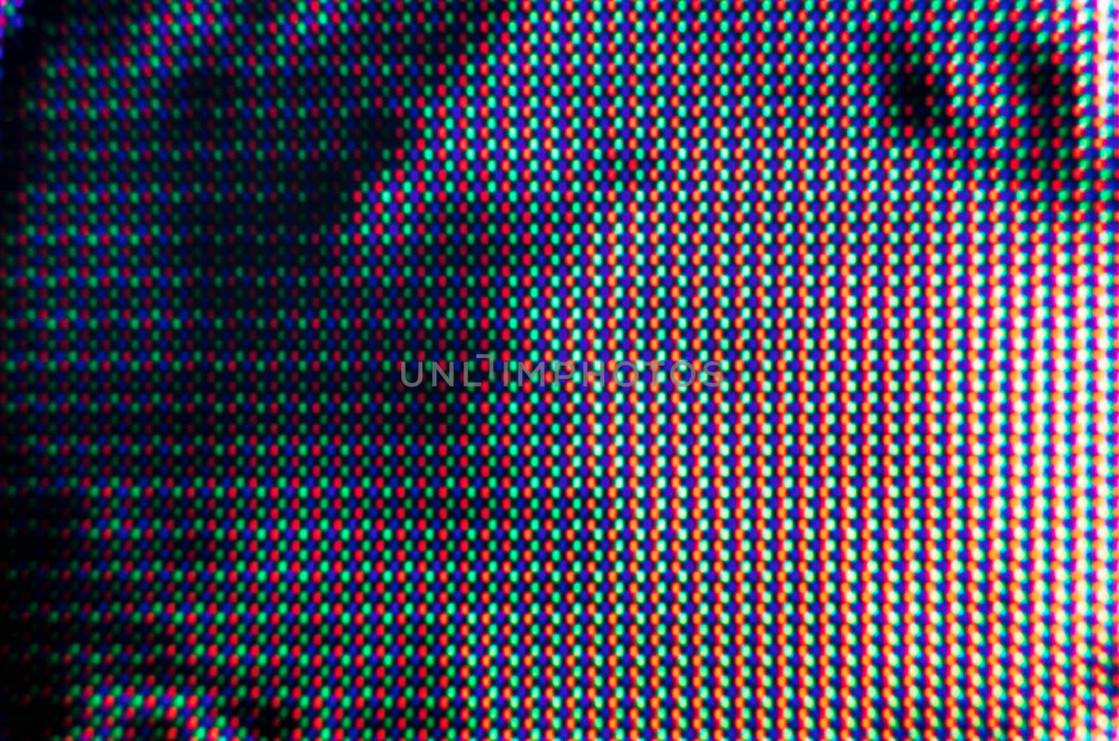 abstract background pattern of colored blurry dots on a dark background close up