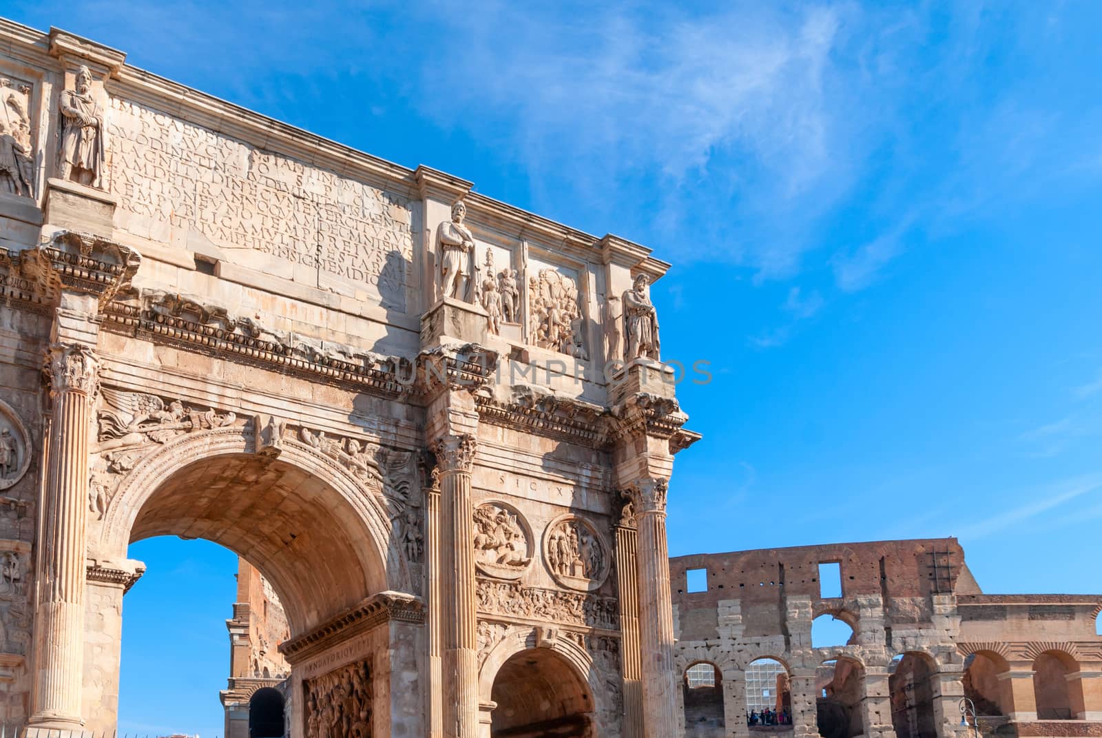 Arch of Constantine and Colosseum in Rome, Italy. Triumphal arch in Rome, Italy. North side, from the Colosseum. Colosseum is one of the main attractions of Rome.