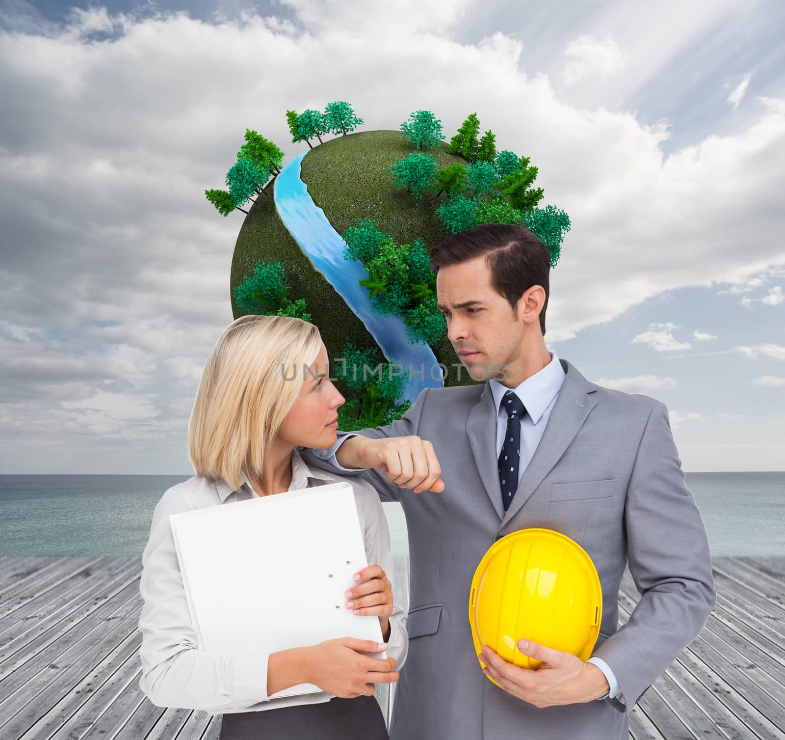 Composite image of architects with plans and hard hat looking at each other by Wavebreakmedia