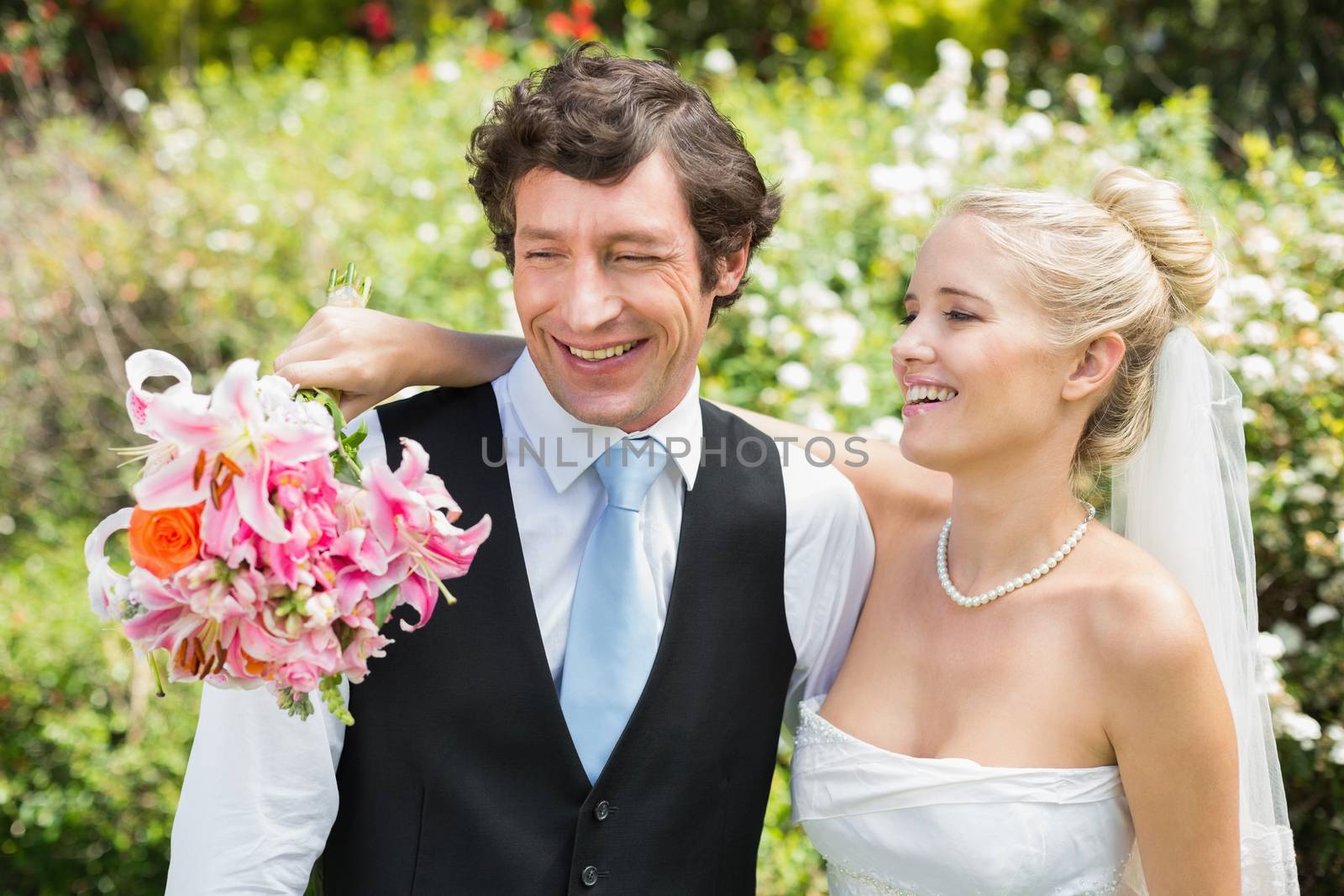 Romantic newlywed couple smiling on their wedding day by Wavebreakmedia