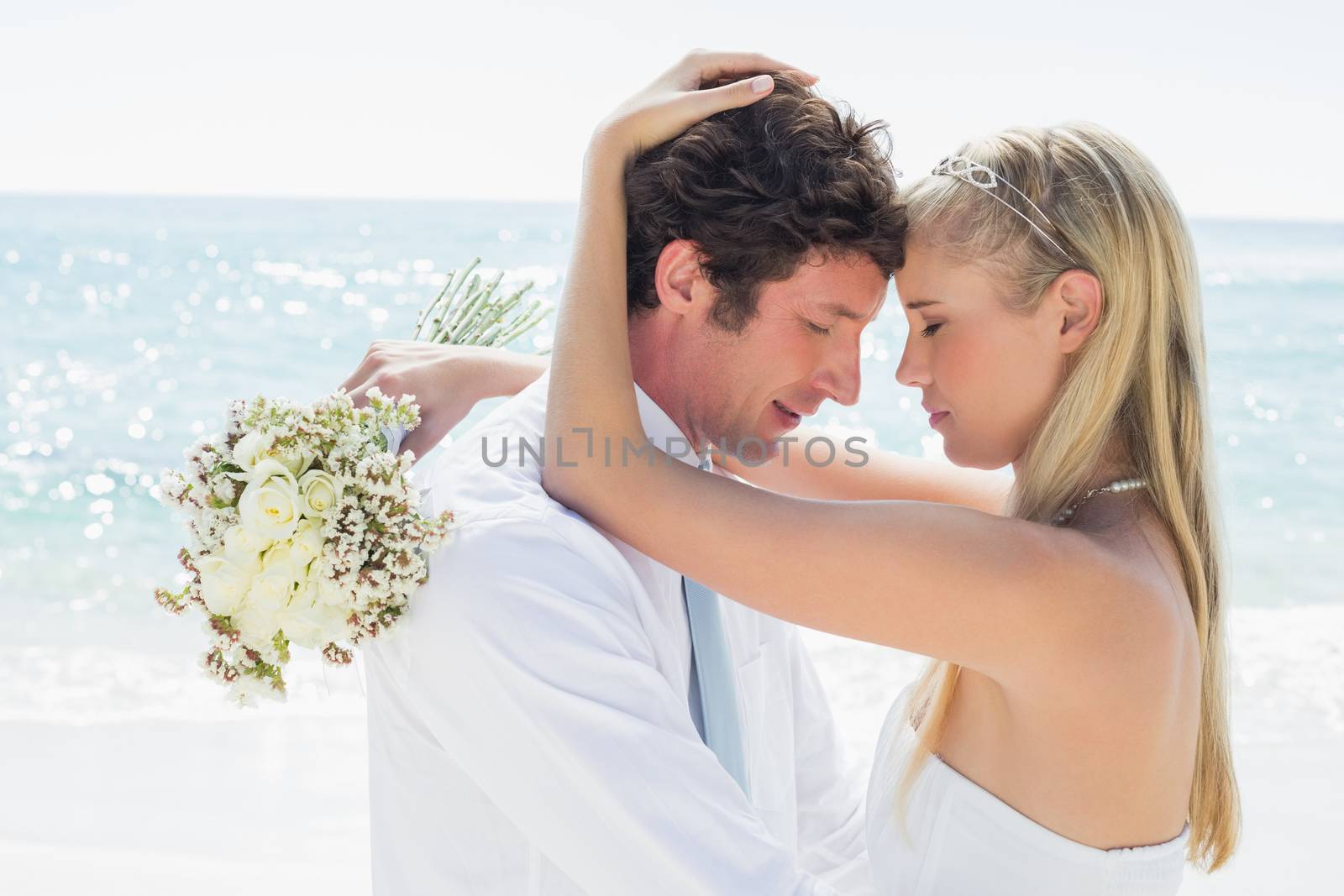 Romantic couple embracing on their wedding day by Wavebreakmedia