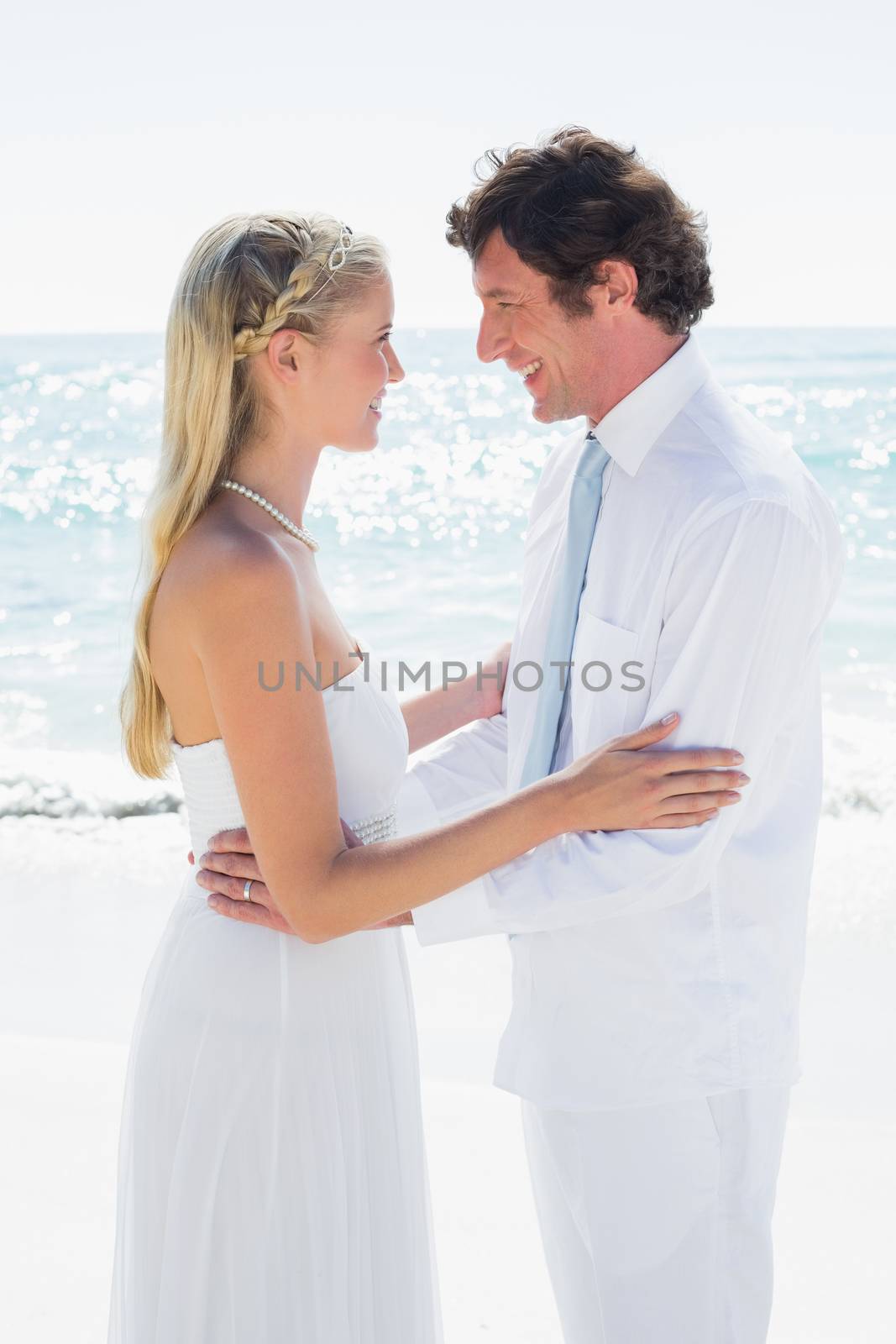 Romantic happy couple on their wedding day at the beach