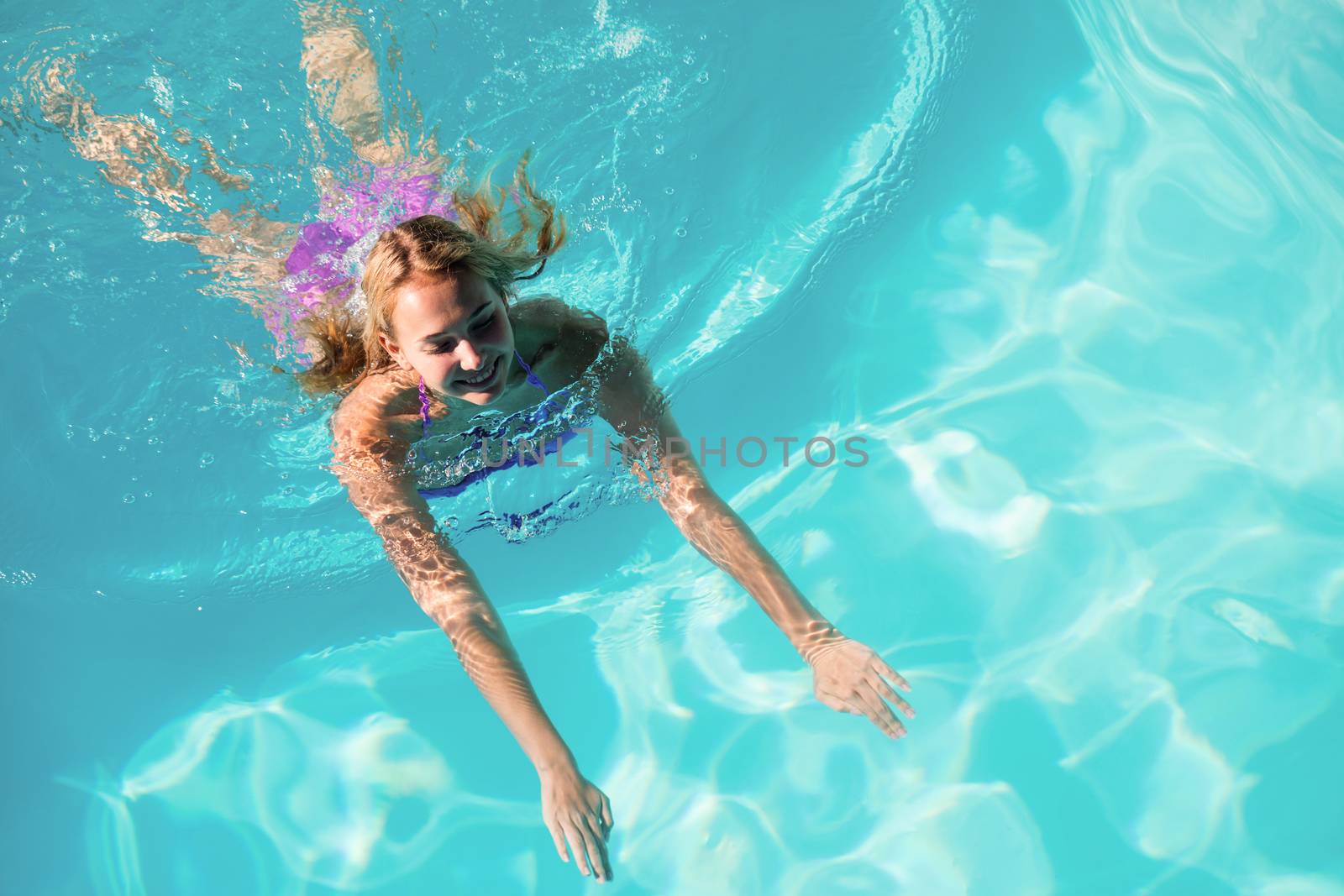 Woman swimming in swimming pool by Wavebreakmedia