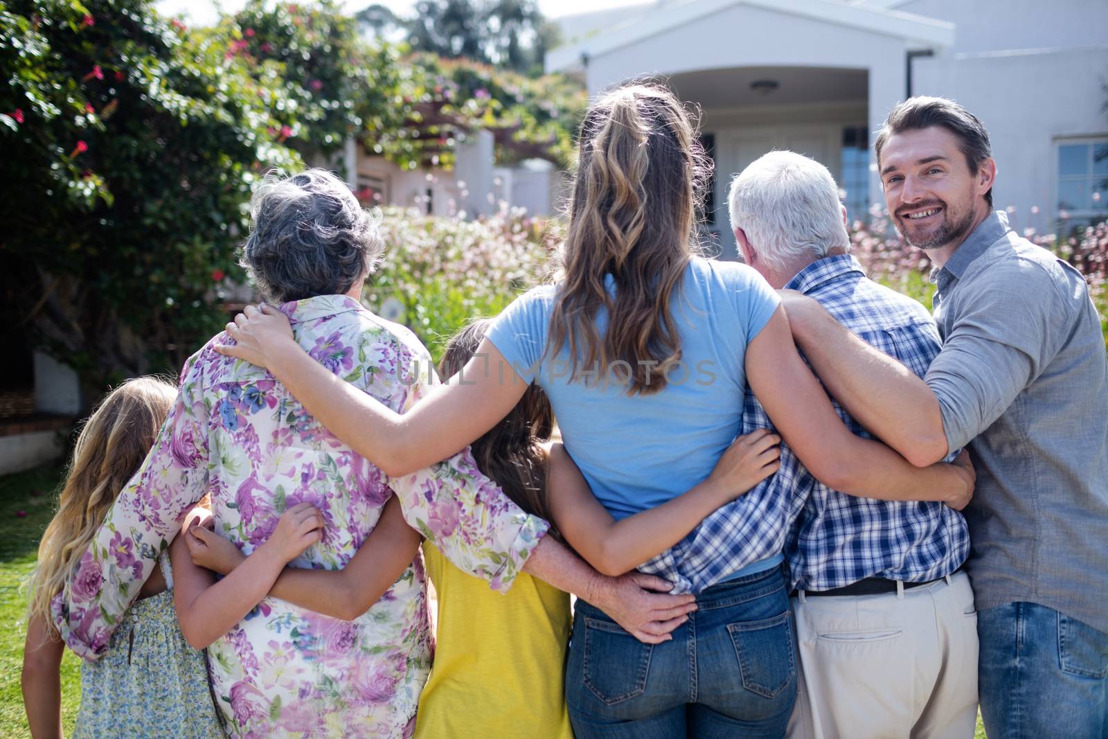 Multi-generation family walking together on the garden path