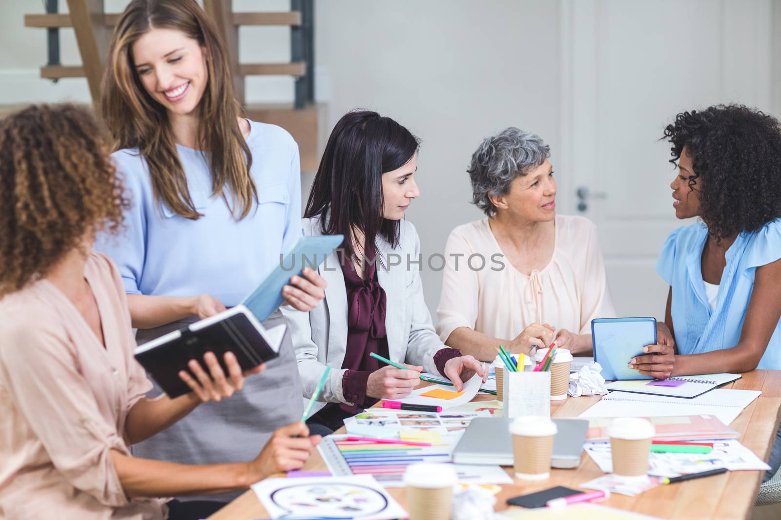 Group of interior designers interacting with each other in office