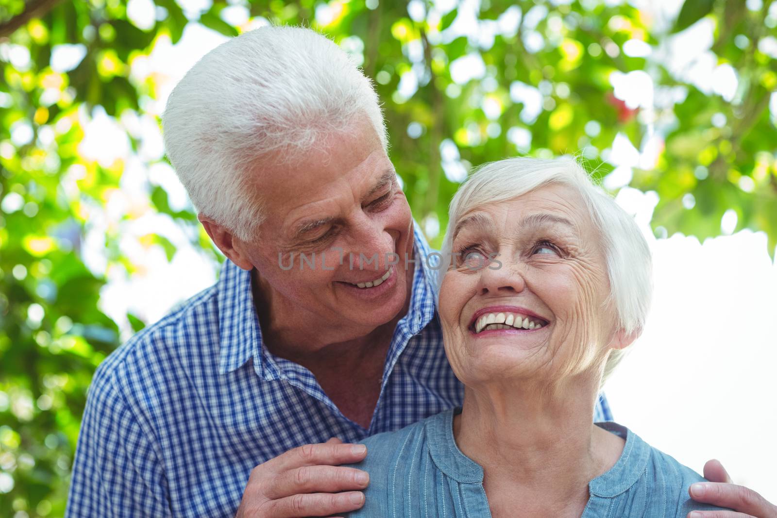 Close-up of happy senior couple standing outdoors