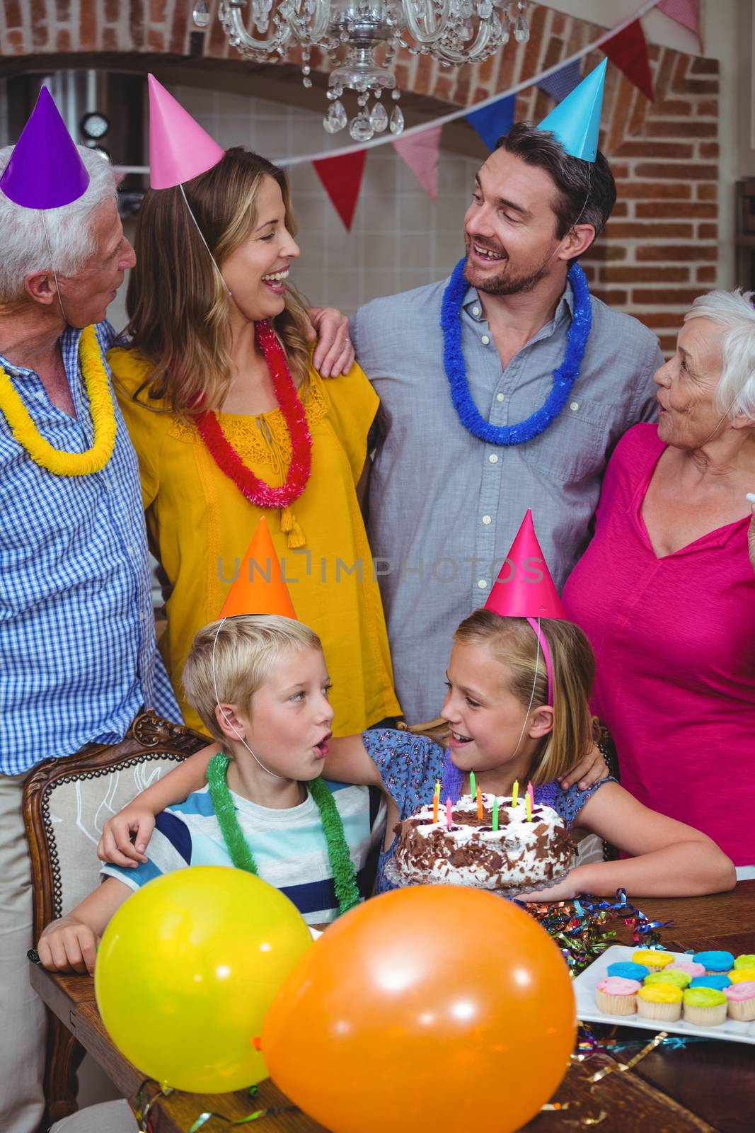 Smiling multi generation family celebrating birthday at home