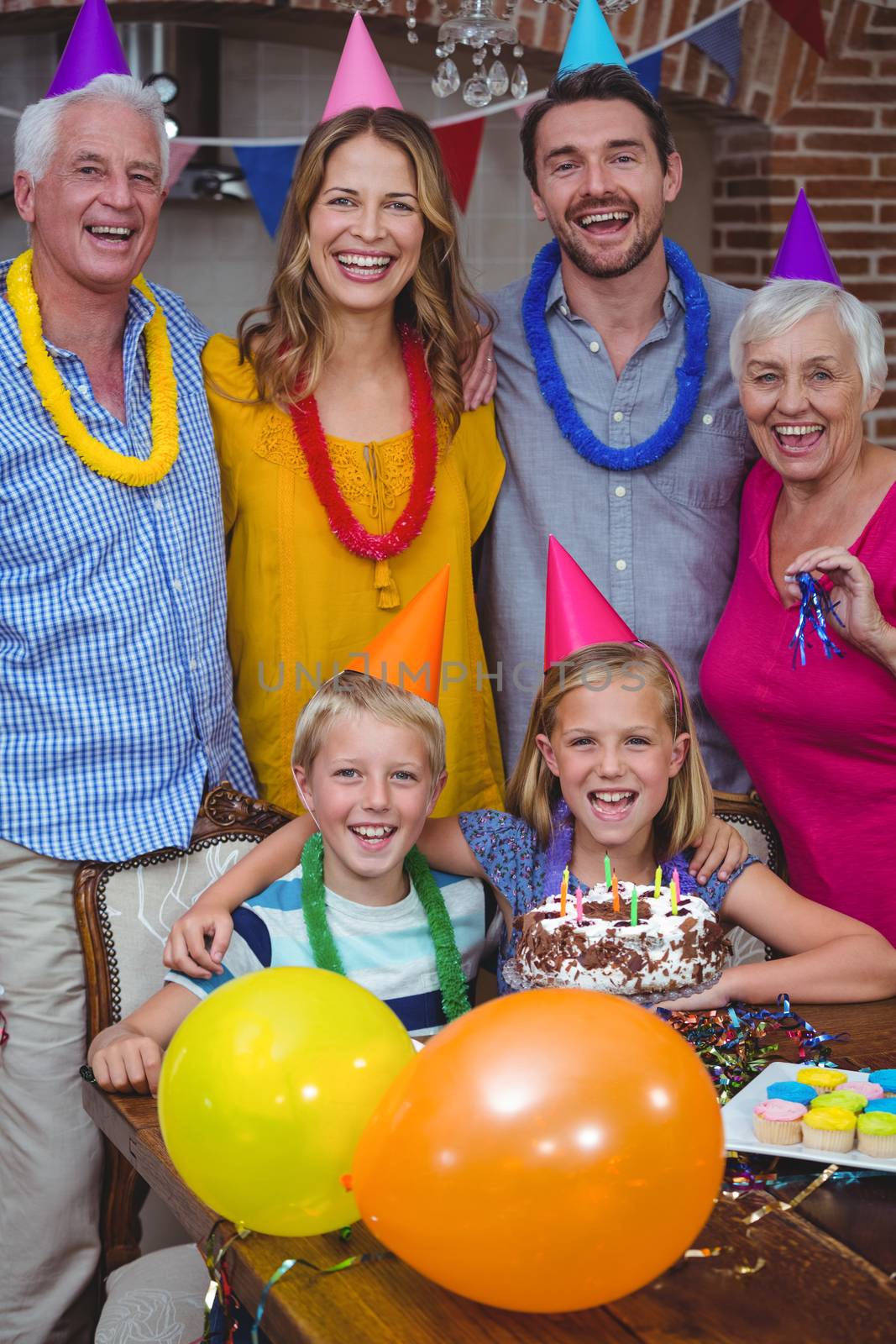 Portrait of smiling multi generation family celebrating birthday at home