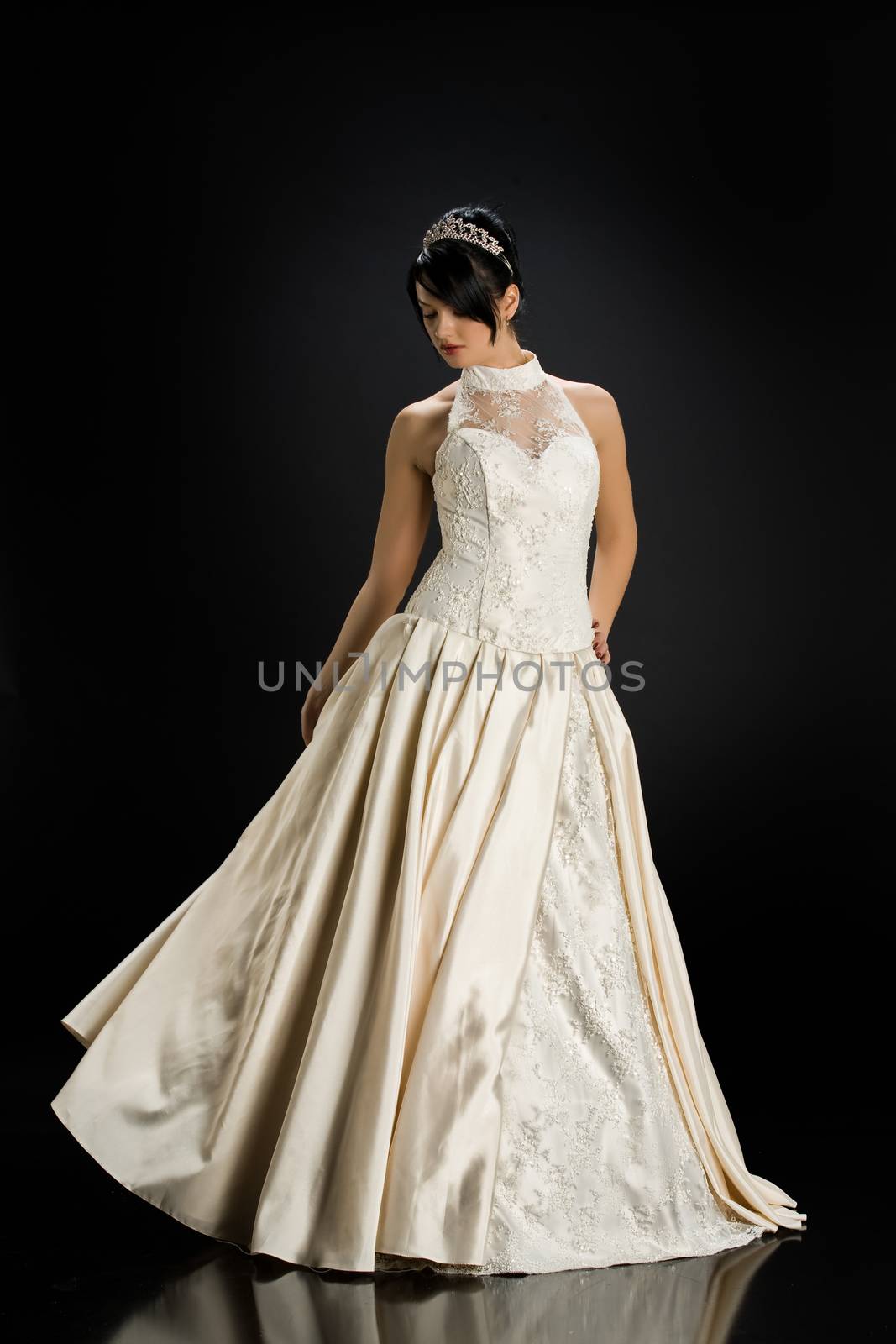 Young beautiful woman in a wedding dress on a studio background