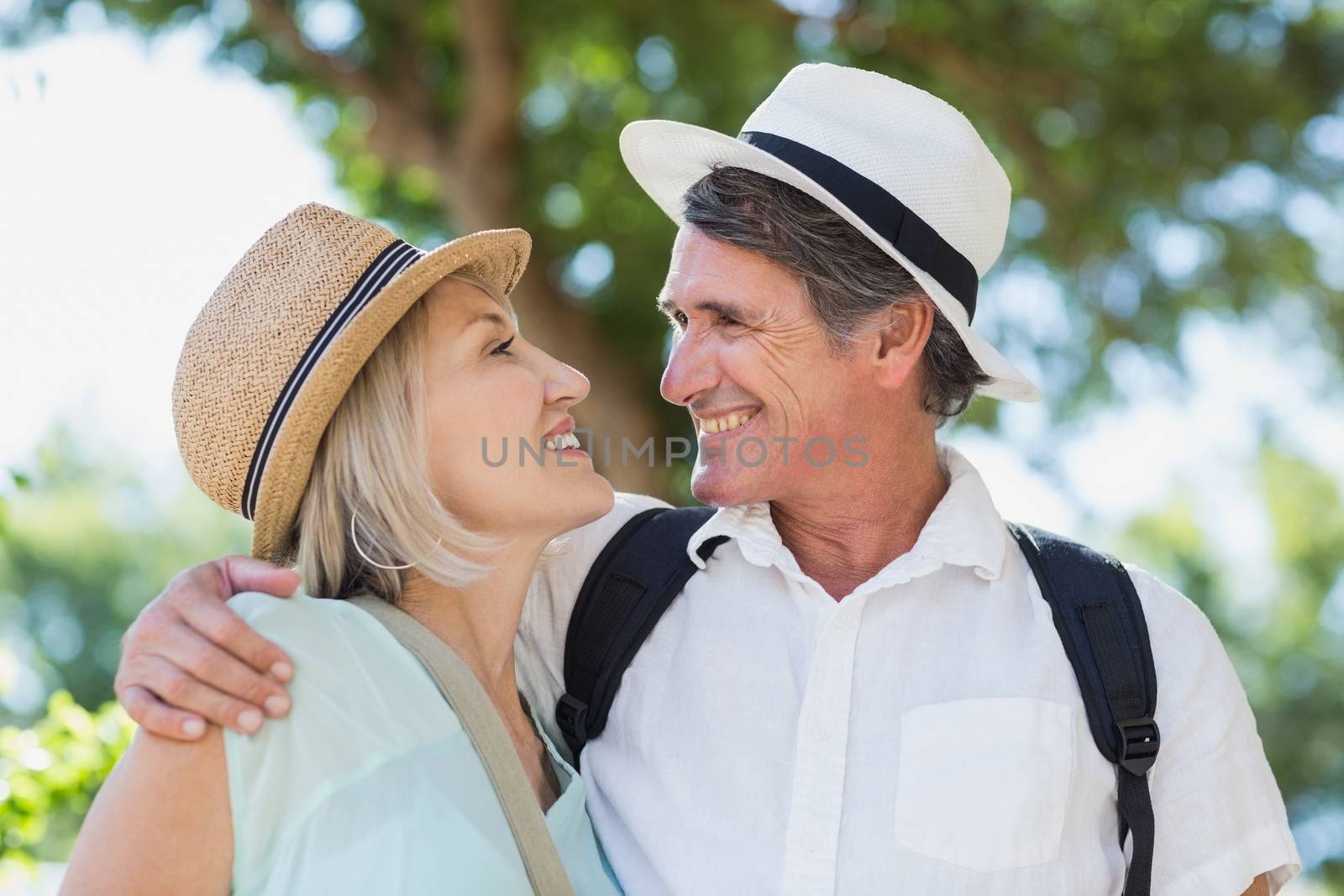 Happy couple looking face to face while standing outdoors