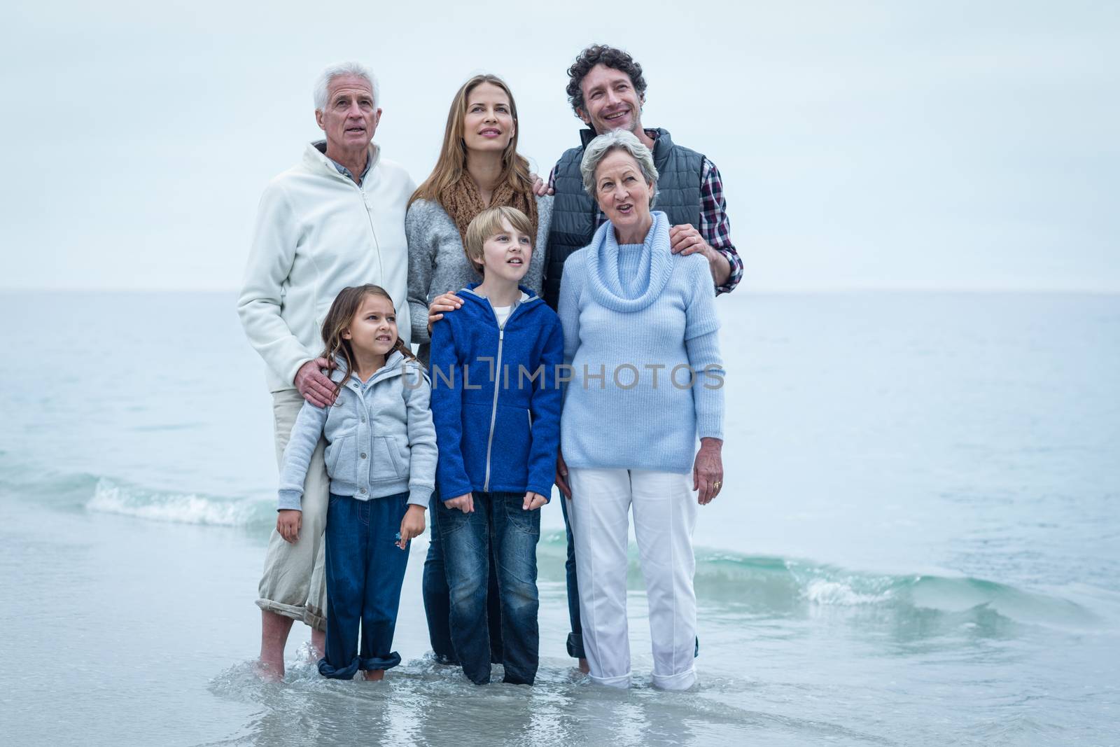 Family standing at beach  by Wavebreakmedia