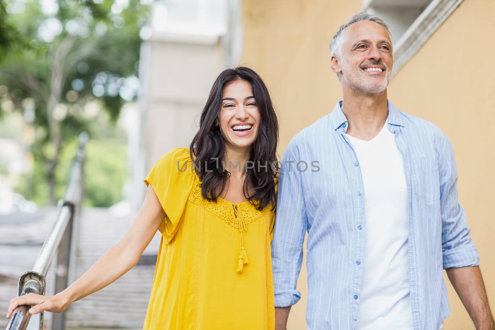 Cheerful couple strolling outdoors by Wavebreakmedia