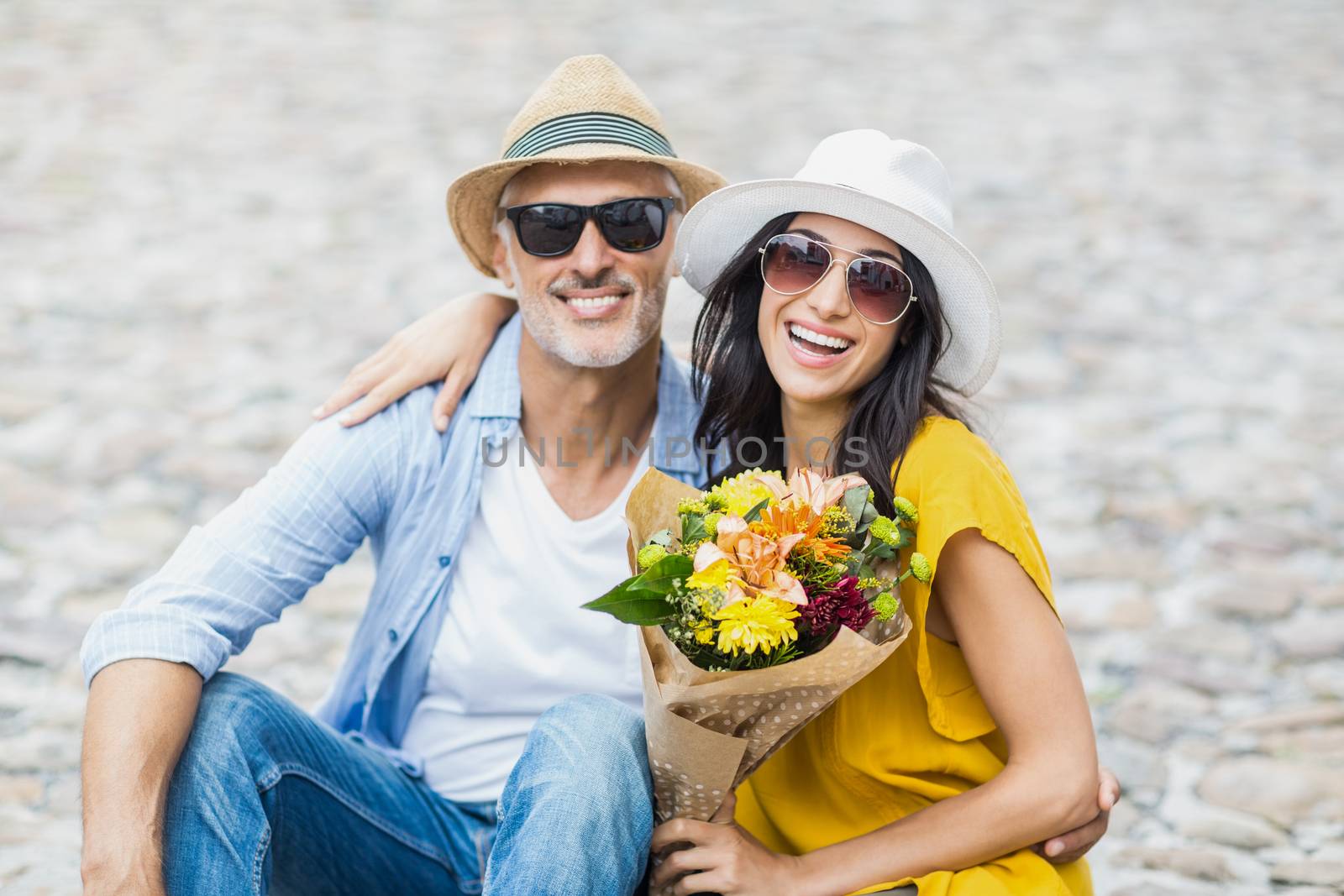 Portrait of happy couple with bouquet by Wavebreakmedia