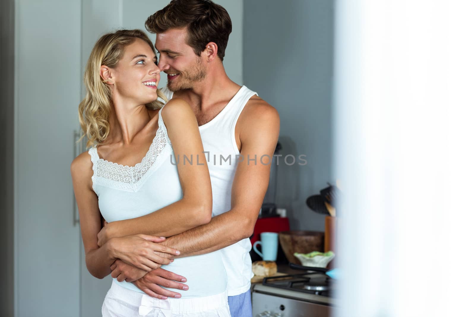 Romantic young couple embracing while looking at each other by Wavebreakmedia