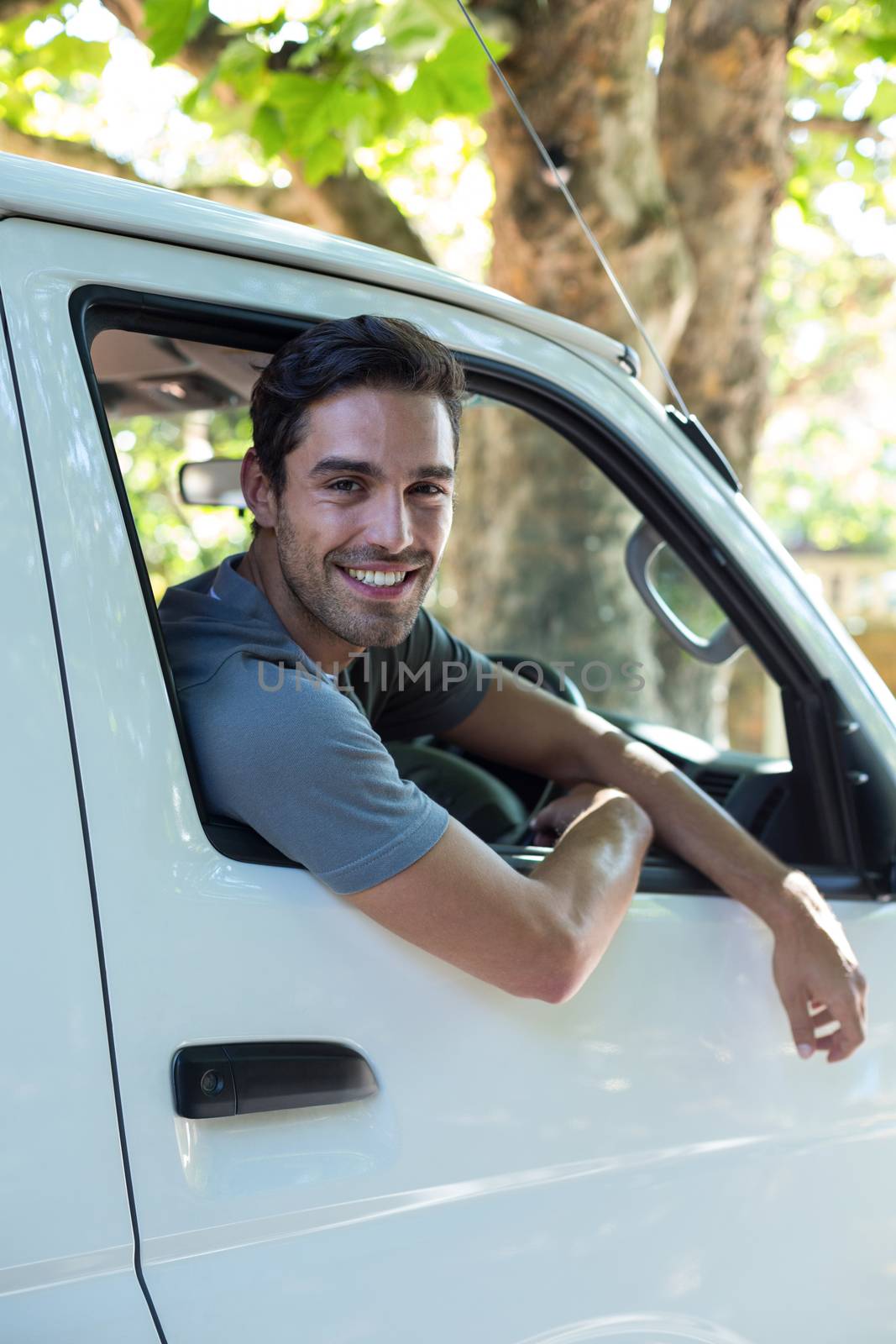 Portrait of smiling man in his van 