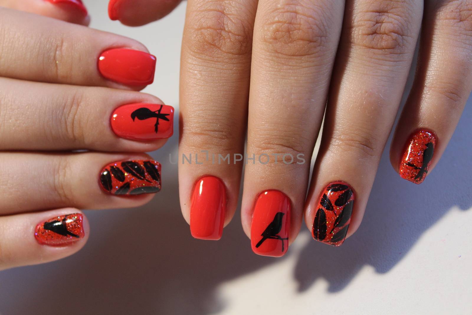 Manicure design red nails with pattern by SmirMaxStock